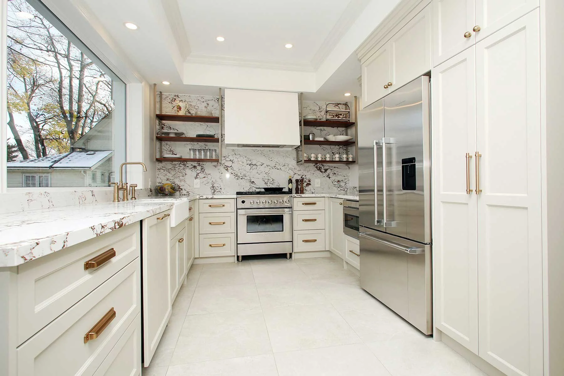After renovation, kitchen veined marble countertop and warm grey cabinetry in Etobicoke. 