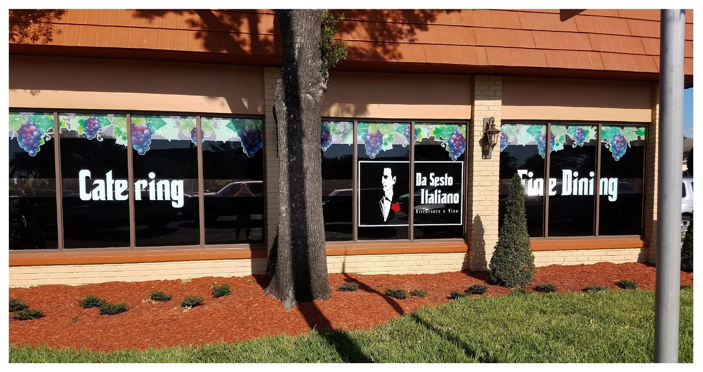 Exterior of "Da Sesto Italiano" restaurant with catering and fine dining signs in windows. colored window film