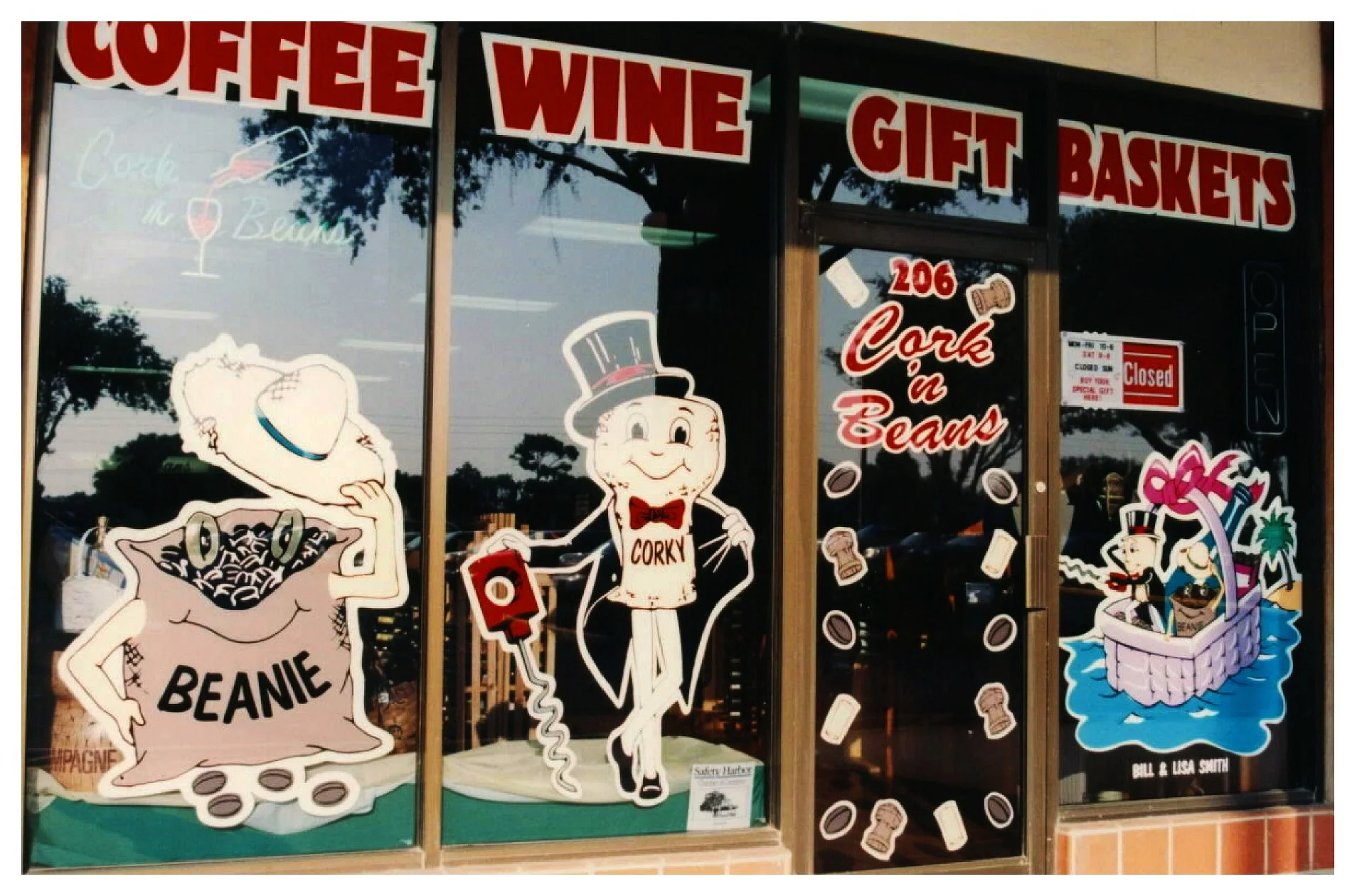 Cork n Beans store front with coffee, wine, gift baskets signs, and cartoon characters on windows. colored window film