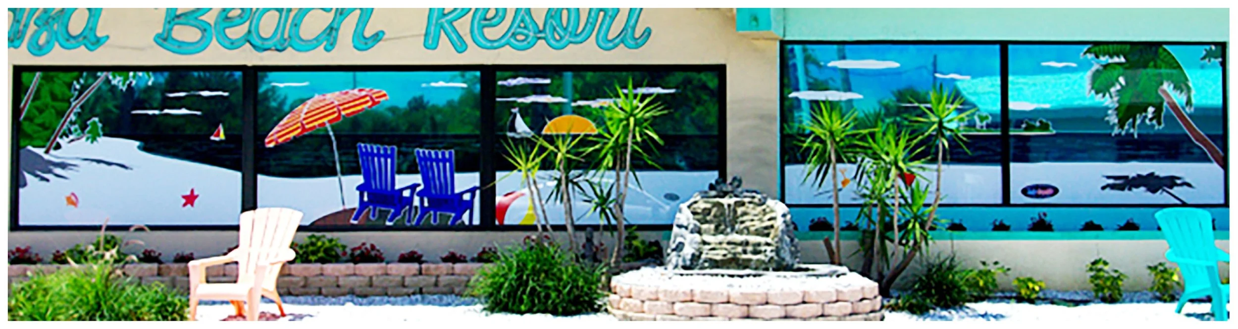 painted beach resort scene on windows with chairs, umbrella, plants, and water fountain colored window film
