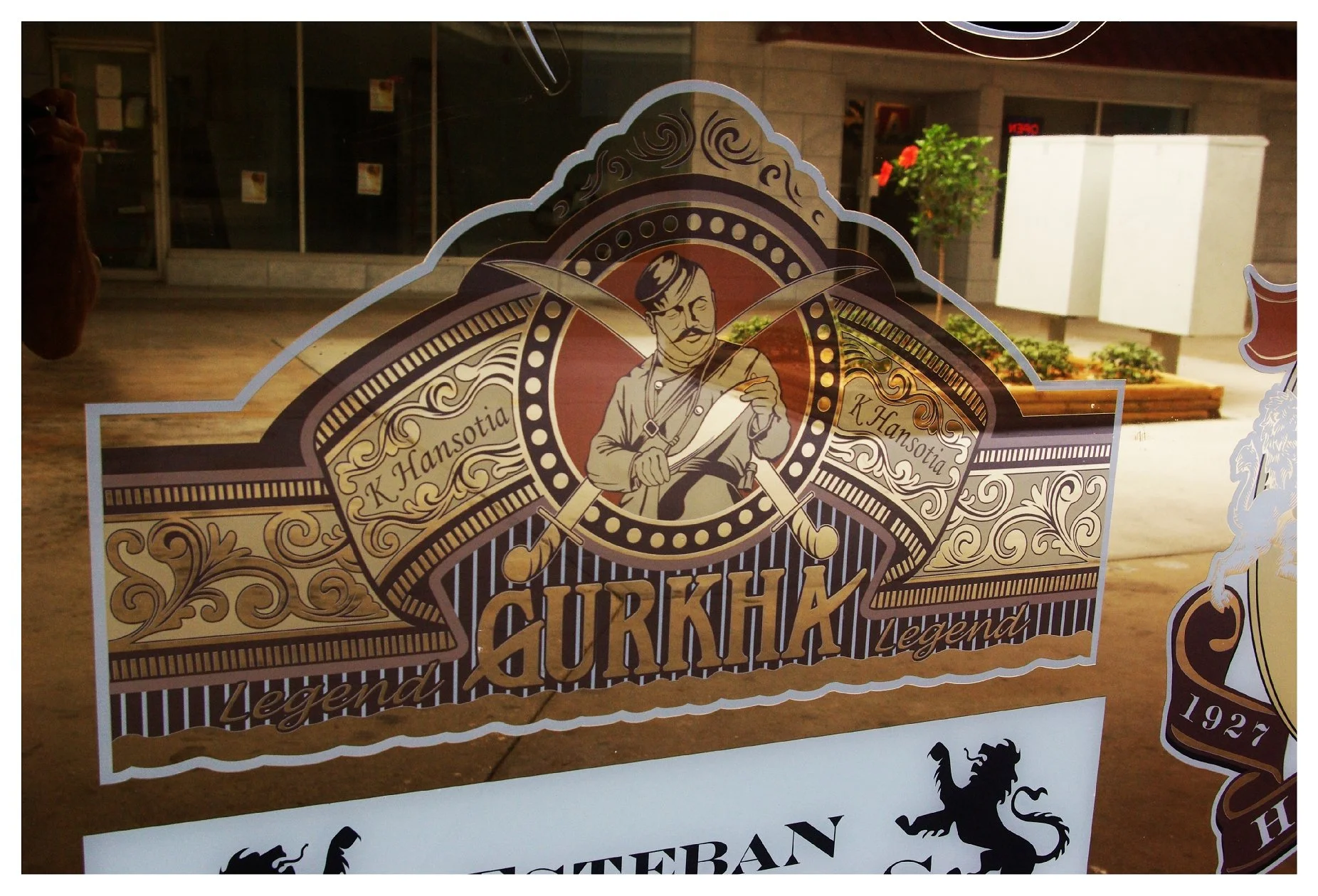 Gurkha cigar logo on a storefront window colored window film