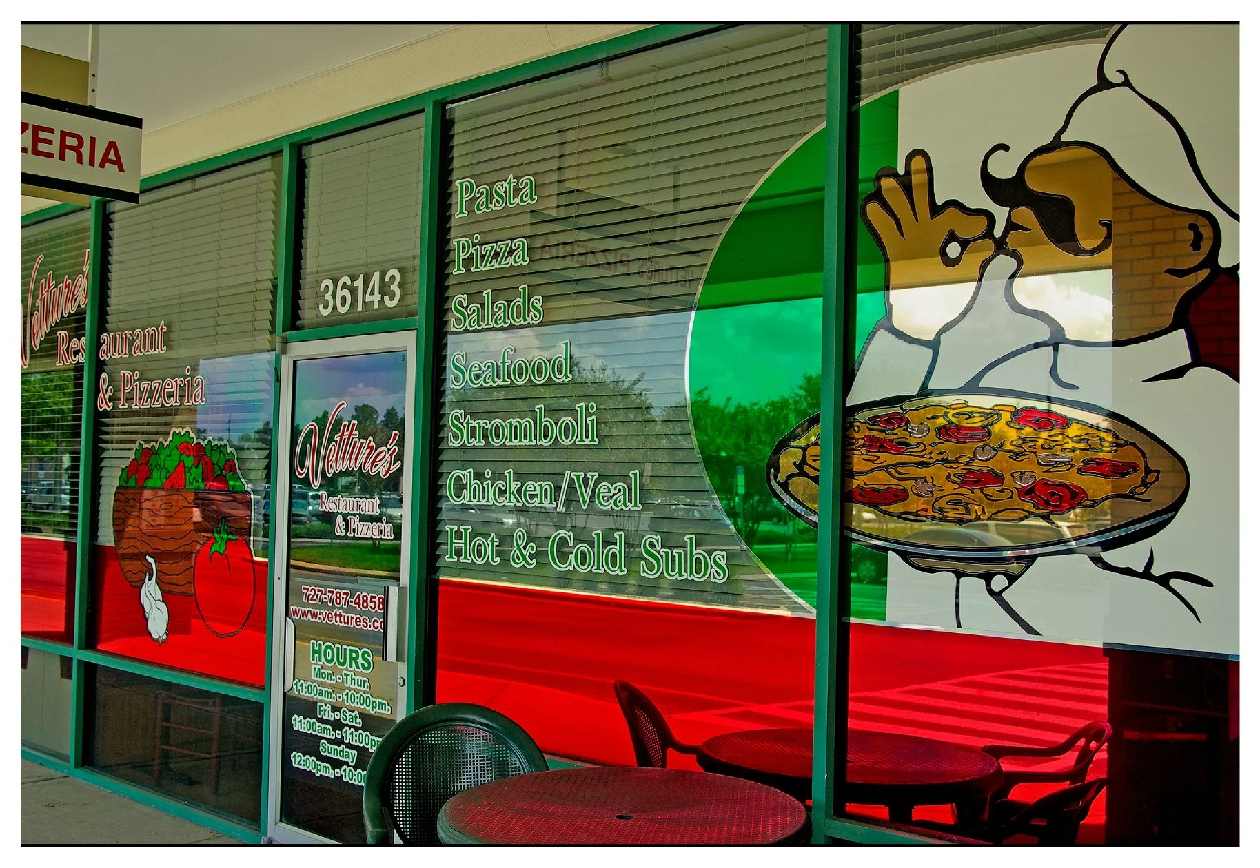 Exterior of Italian restaurant with chef illustration, menu offerings, and contact info on window. colored window film