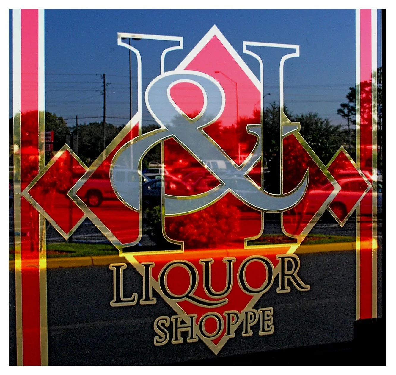 H & L Liquor Shoppe window signage with red and gold design colored window film