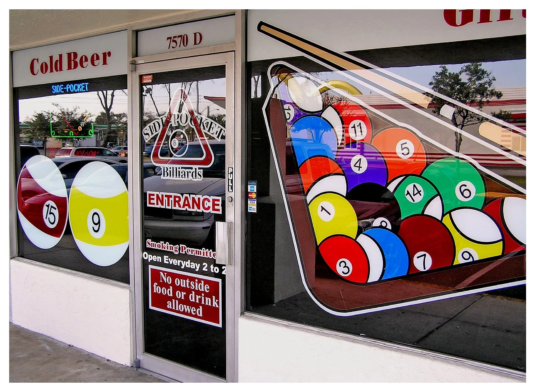 Billiards hall entrance with colorful pool ball graphic on glass door. colored window film