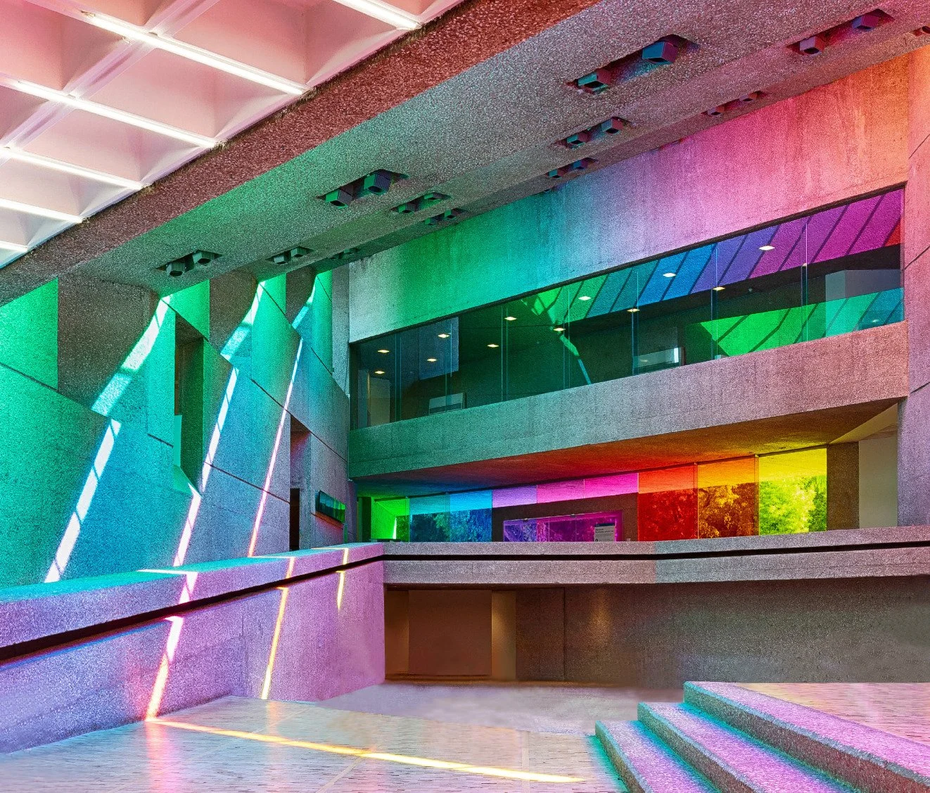 Interior view of a modern building with colorful window film on the glass