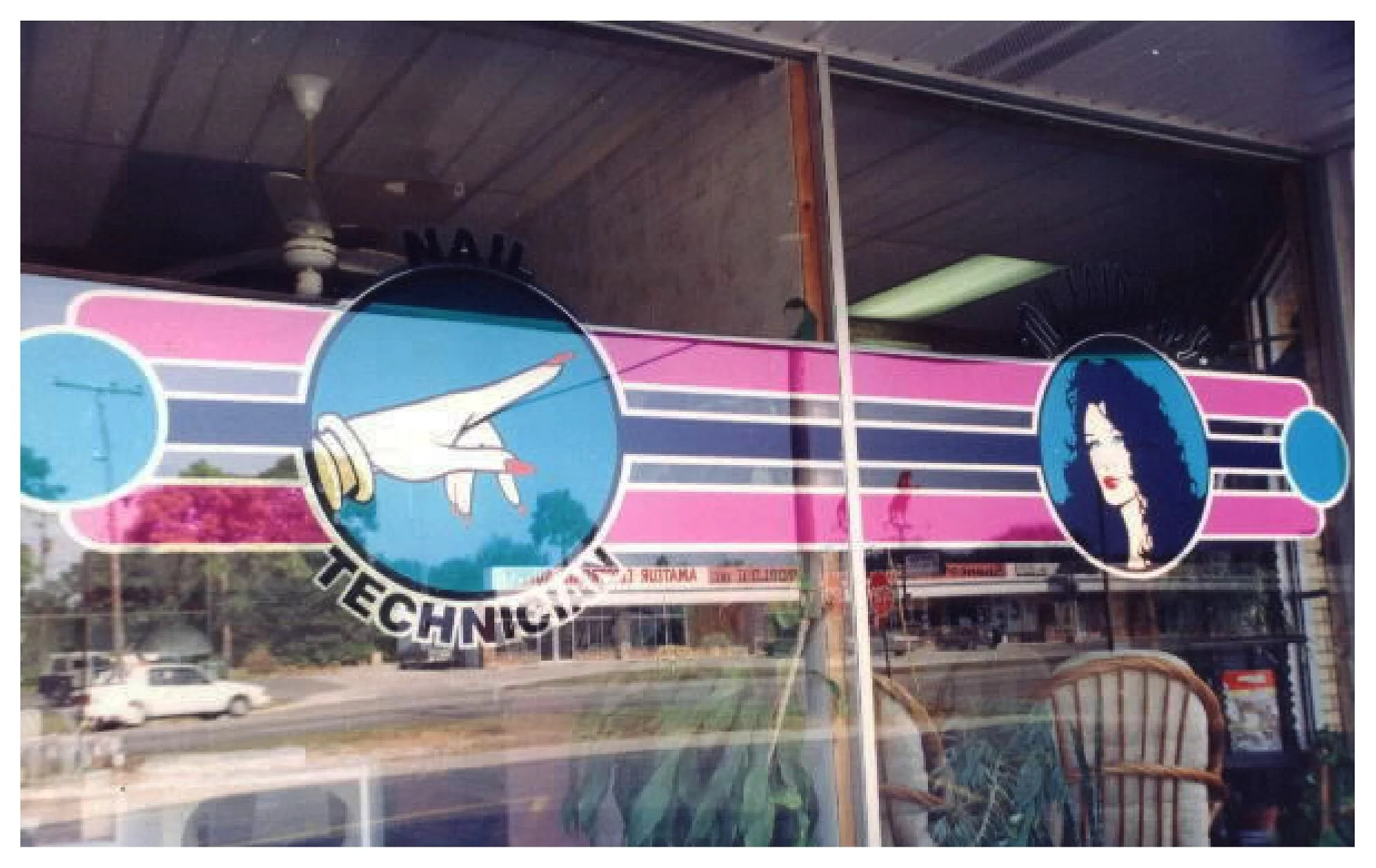 Storefront window with nail technician sign featuring illustration of hand with polished nails and woman's portrait. colored window film