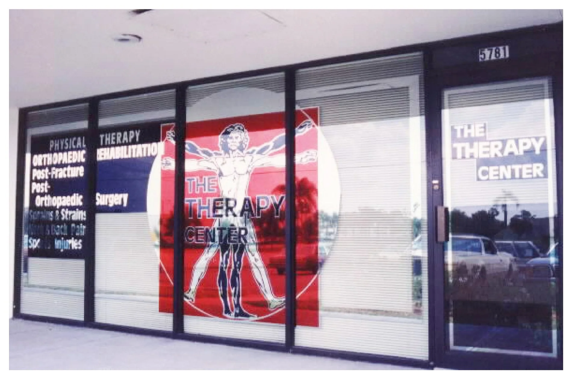 Exterior of "The Therapy Center" showing signage and advertising services like physical therapy and rehabilitation. colored window film