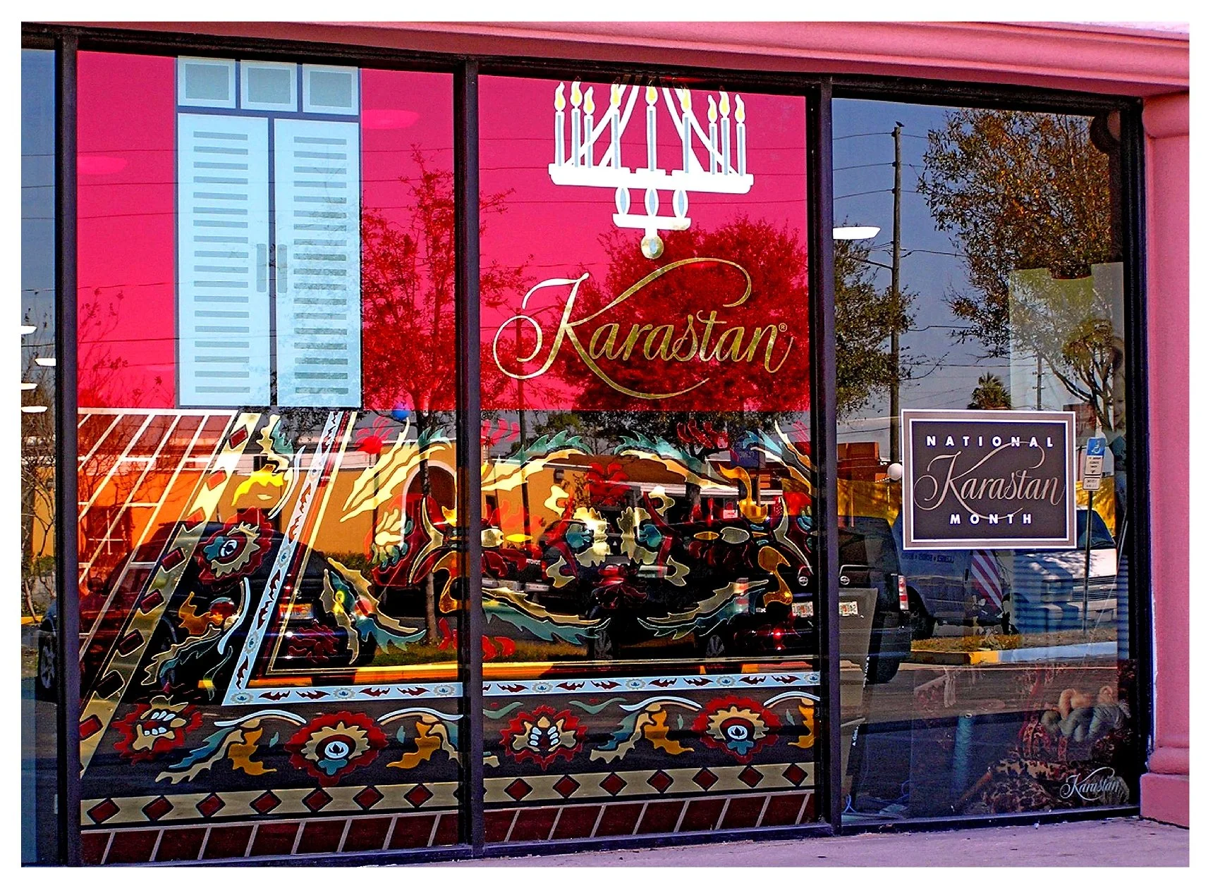 Karastan store window with decorative rug design and signage for National Karastan Month. colored window film
