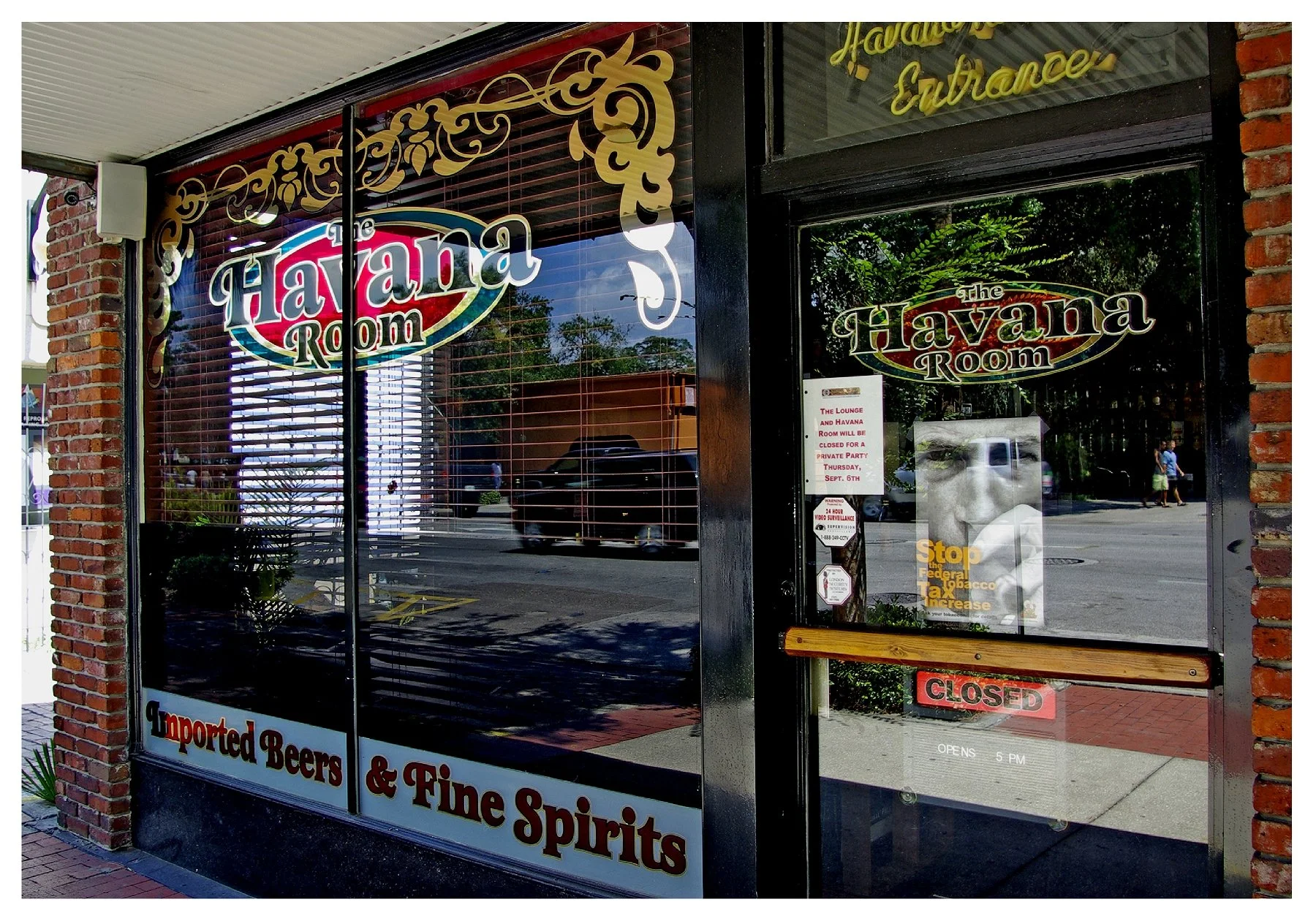 Entrance of the Havana Room with signage for imported beers and fine spirits colored window film