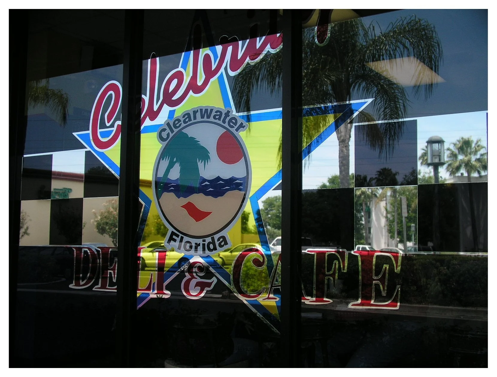 Window sign for Clearwater Florida Deli & Cafe with tropical theme