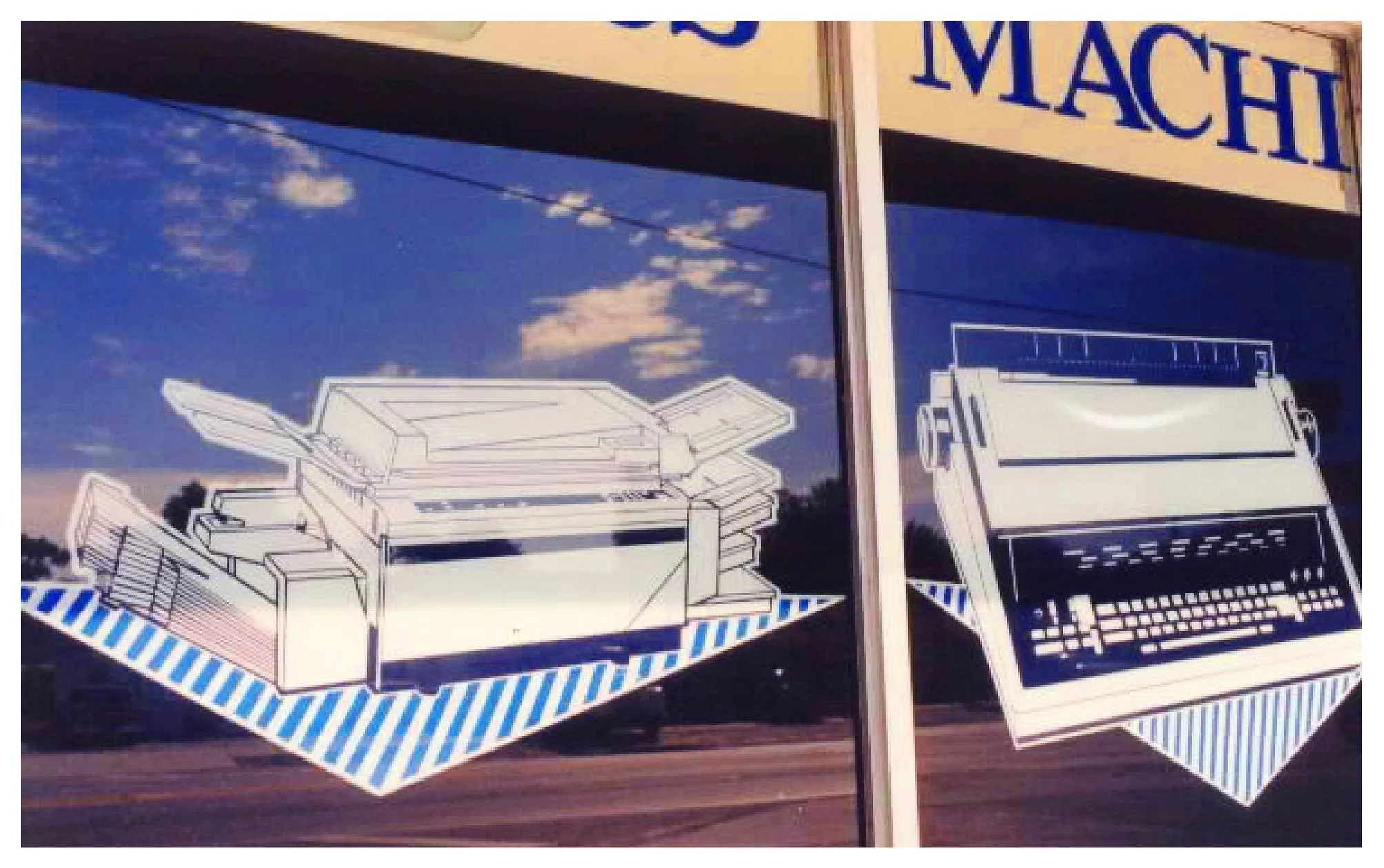 Storefront window with illustrations of office machines, including a printer and a typewriter, reflected against a cloudy sky. colored window film