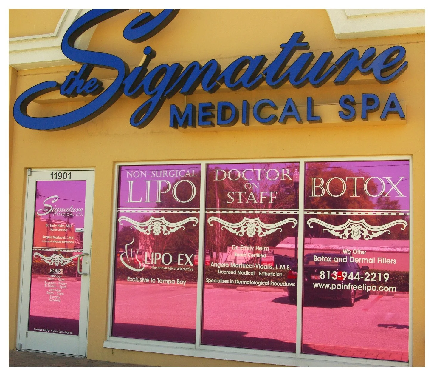 Entrance of the Signature Medical Spa with signs advertising non-surgical lipo, doctor on staff, and botox services. colored window film