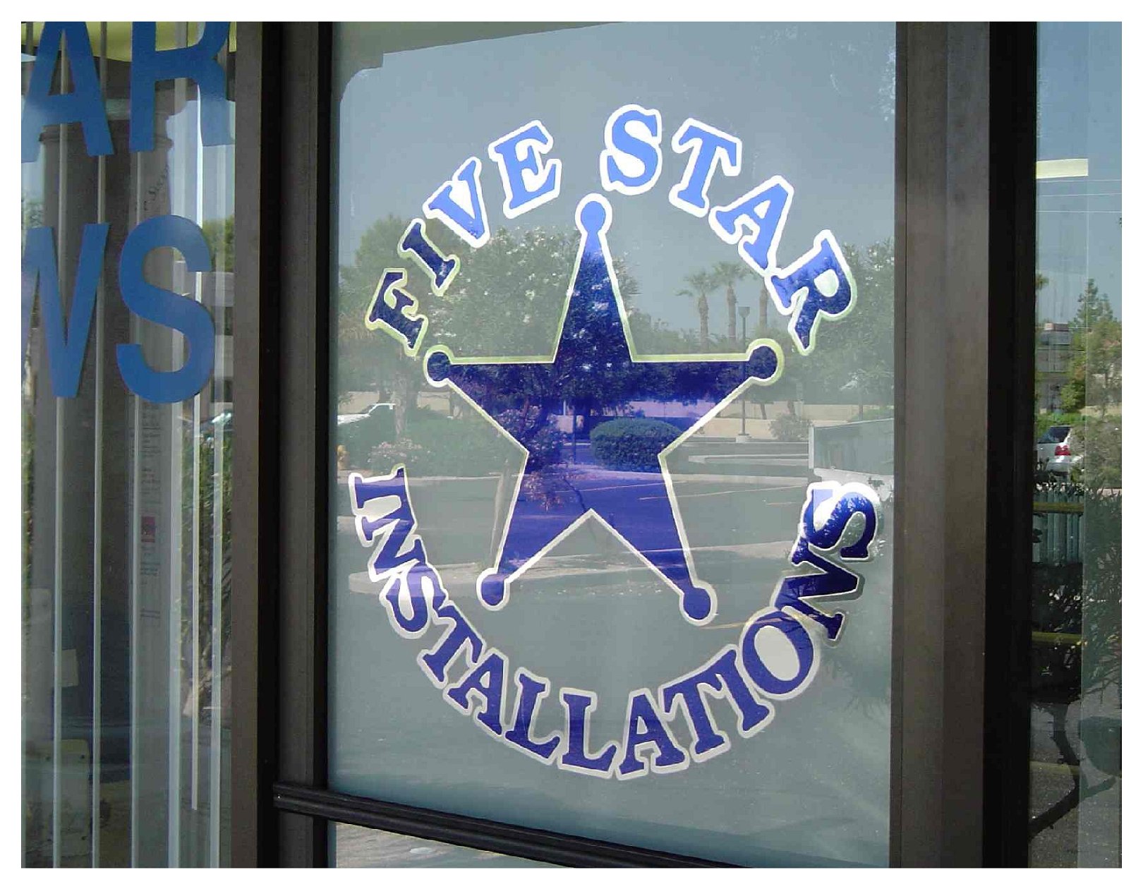 Storefront window with 'Five Star Installations' logo colored window film