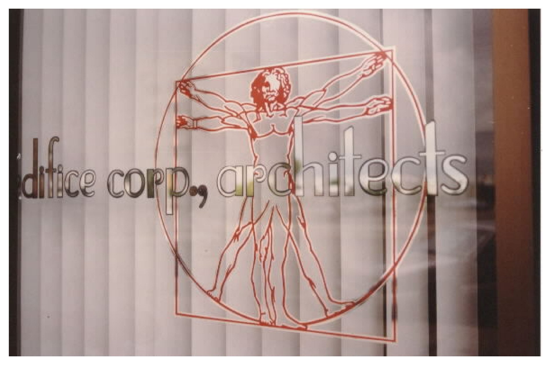 Vitruvian Man with text "edifice corp, architects" on glass window. colored window film