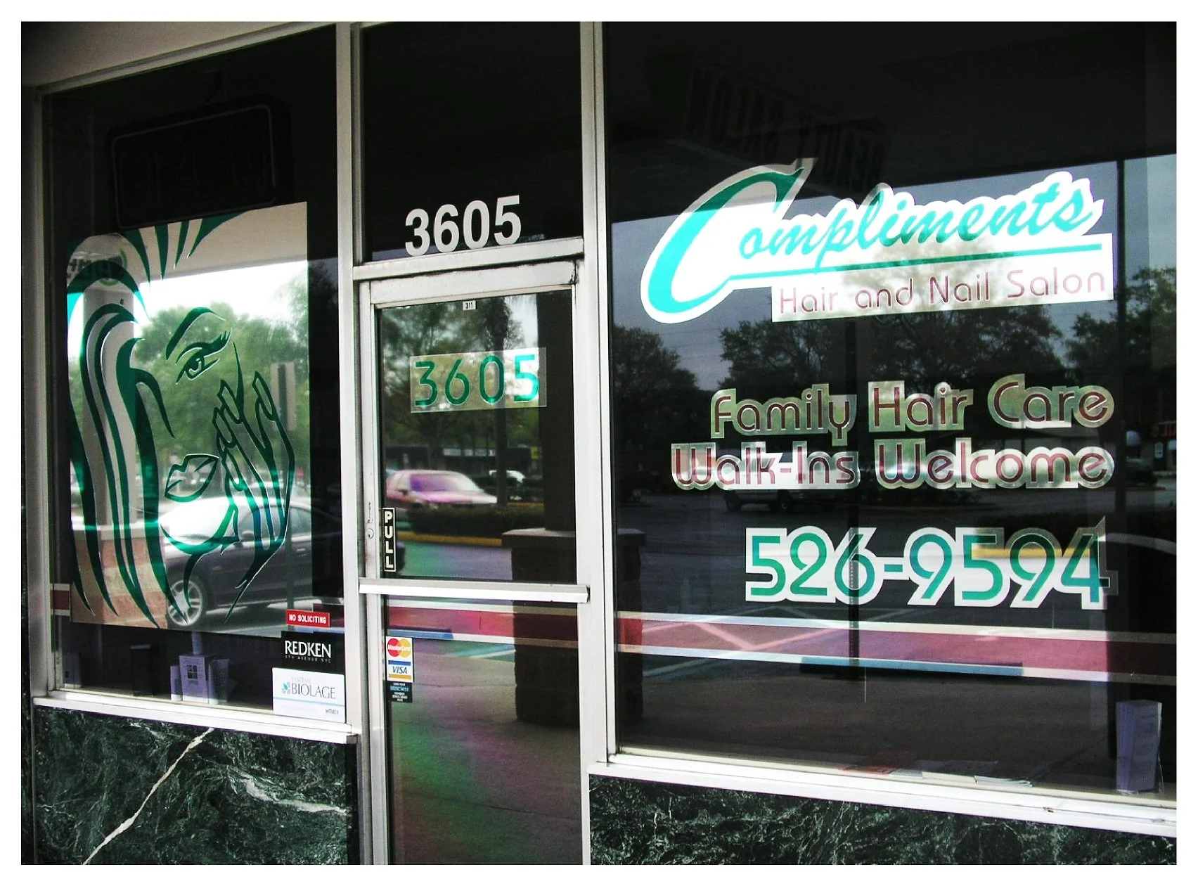 Front of a hair and nail salon with signage displaying contact information, services offered, and inviting walk-ins. colored window film