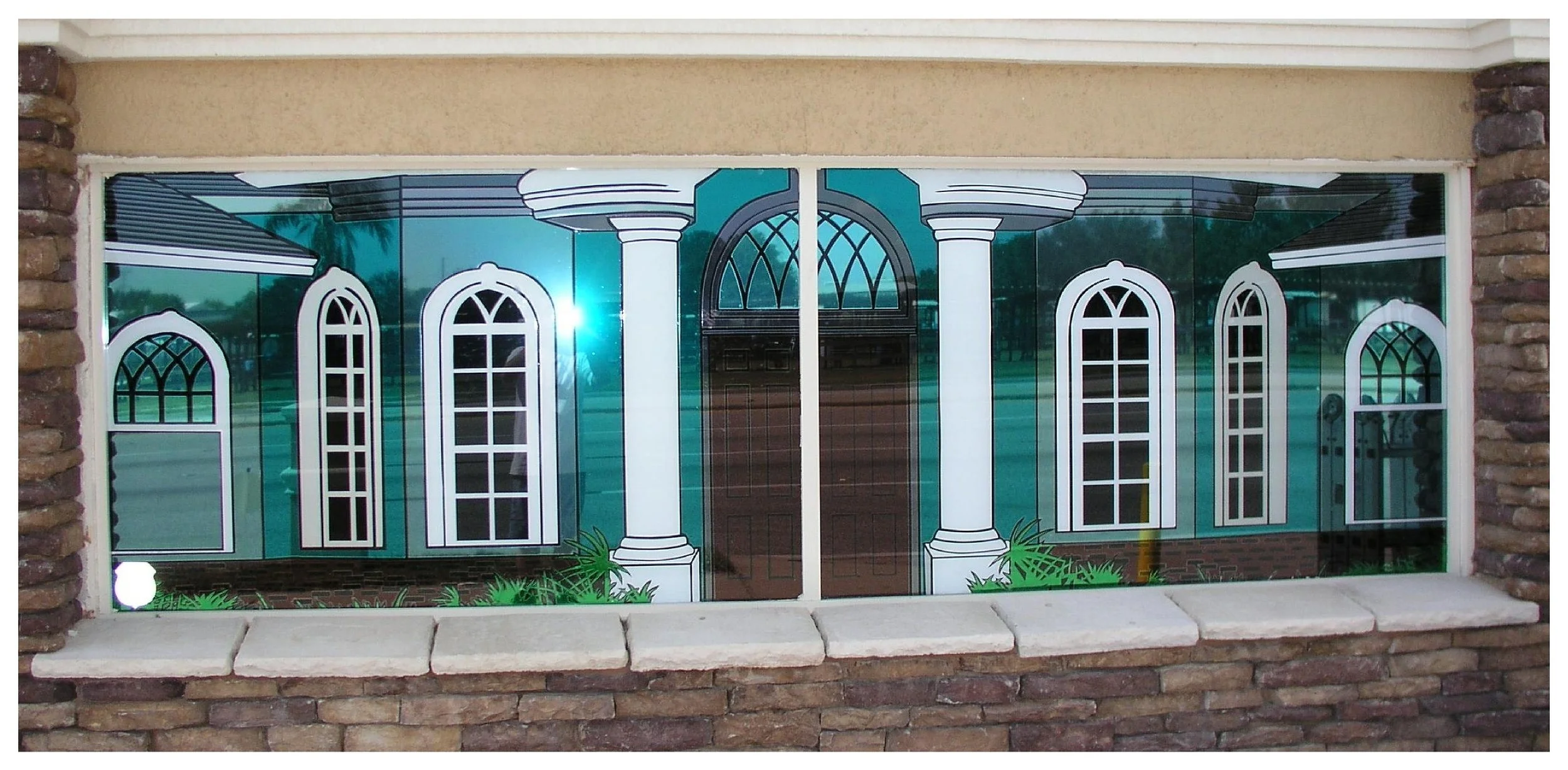 Decorative window mural depicting arches and columns on glass. colored window film