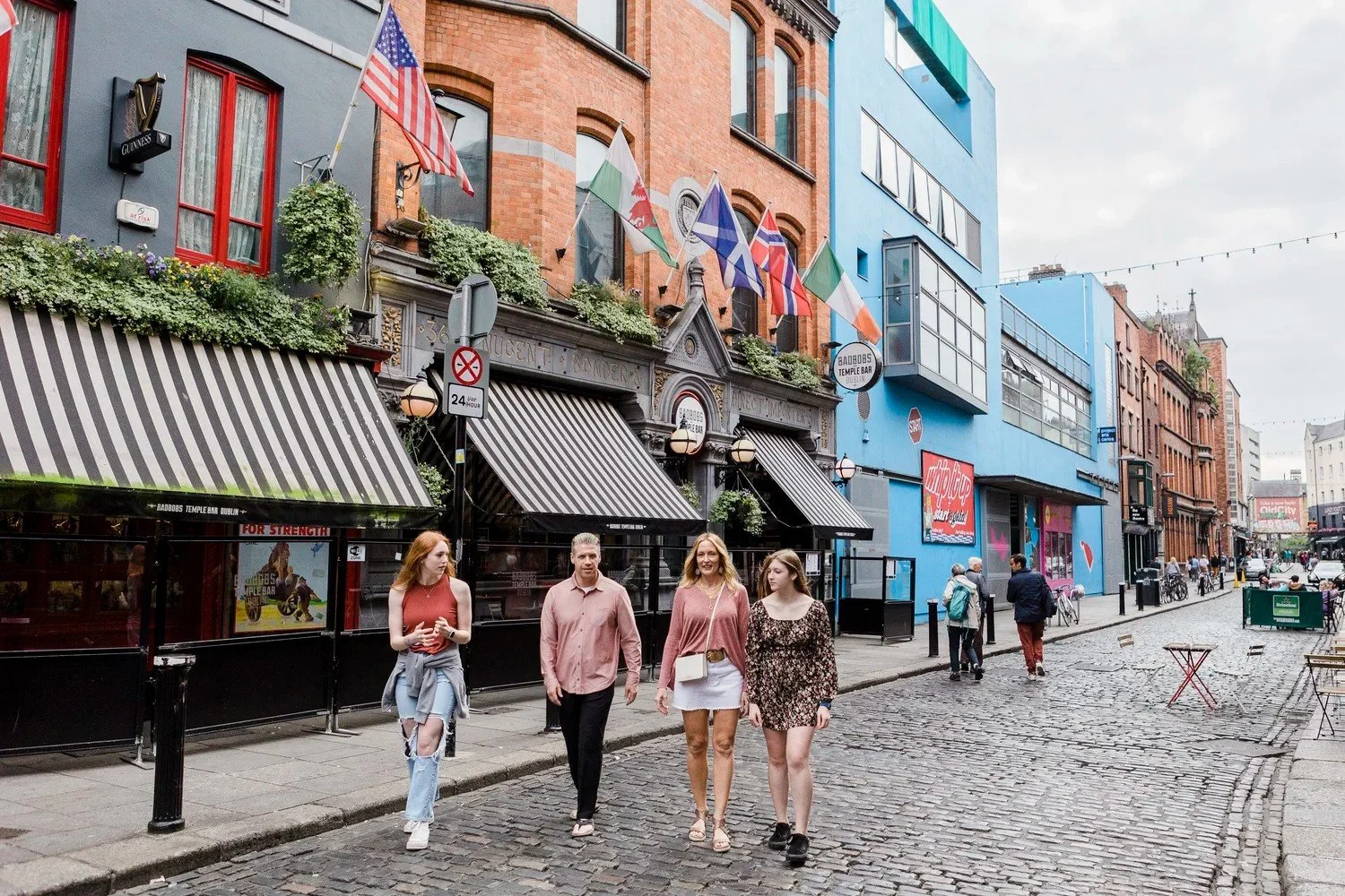 Family walking together through the Temple Bar district of Dublin, Ireland