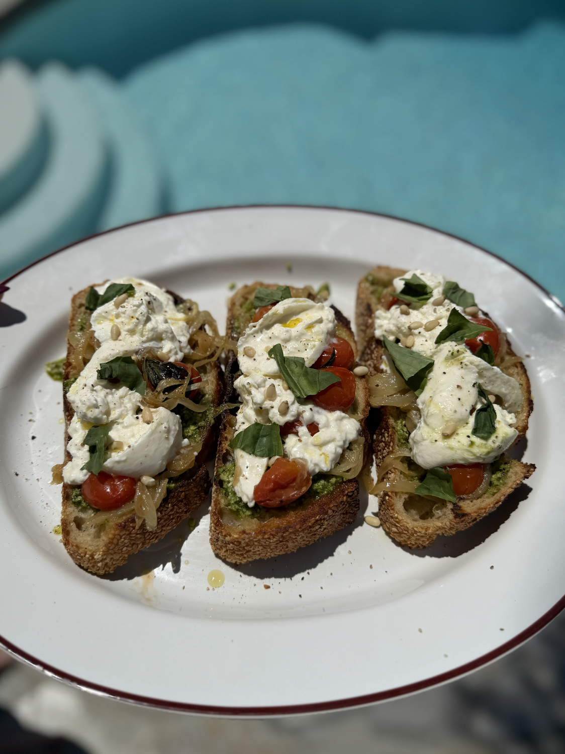 Pesto Crostoni with Caramelized Onion, Blistered Tomato &amp; Burrata