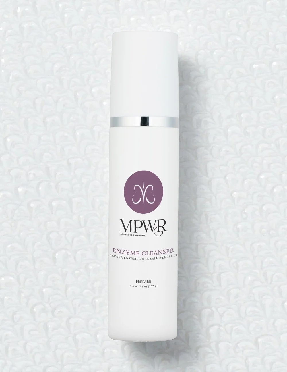 White bottle of MPWR enzyme cleanser with black and gray logo, metal accent, and white pump dispenser.