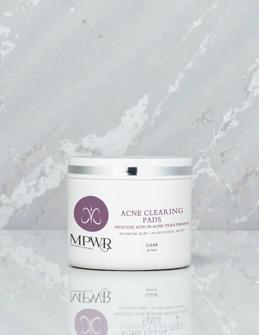 Container of MPWR acne clearing pads with a white lid and label indicating salicylic acid, lactic acid, and glycolic acid for acne treatment.