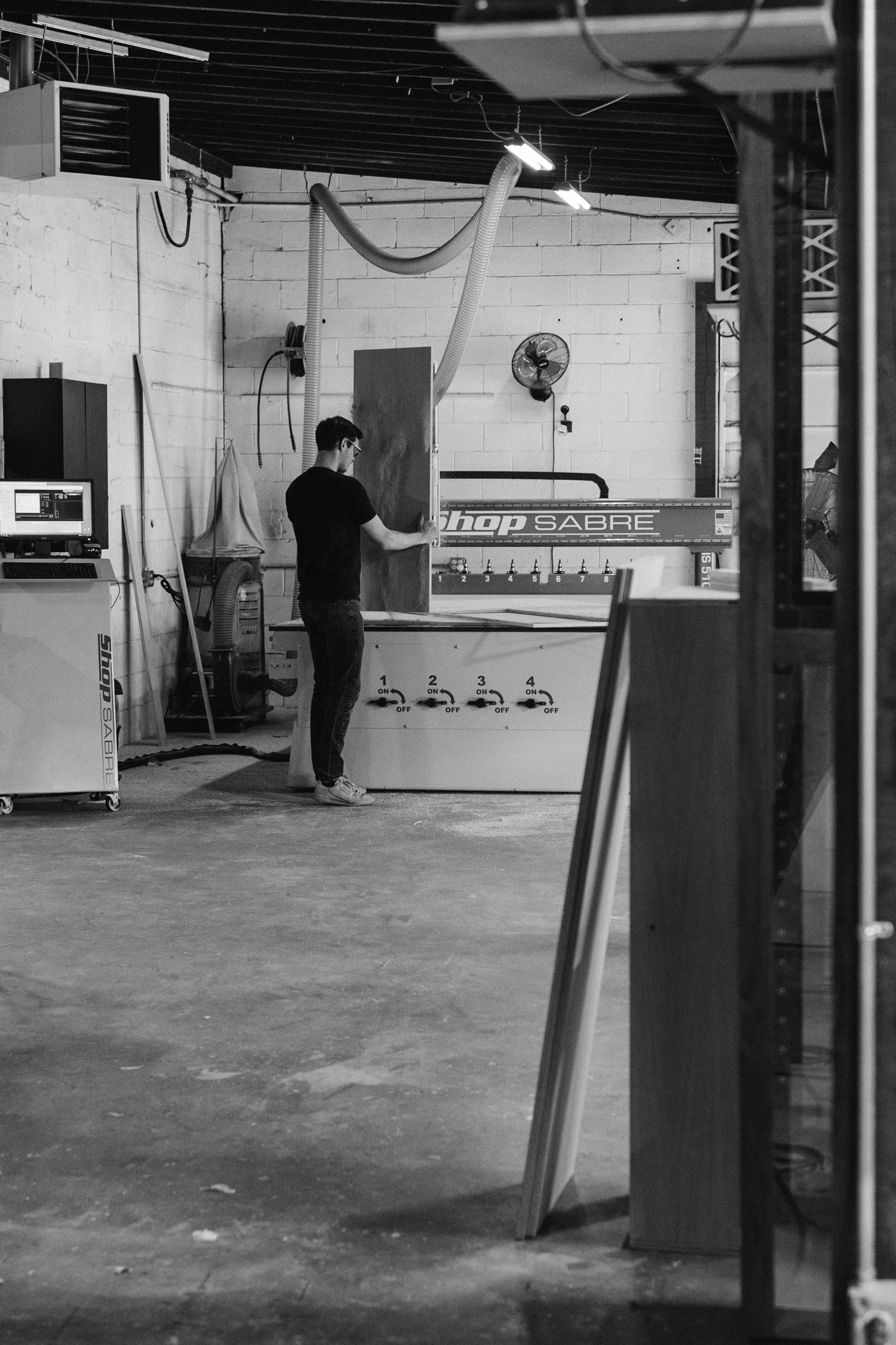 Person in workshop using CNC machine