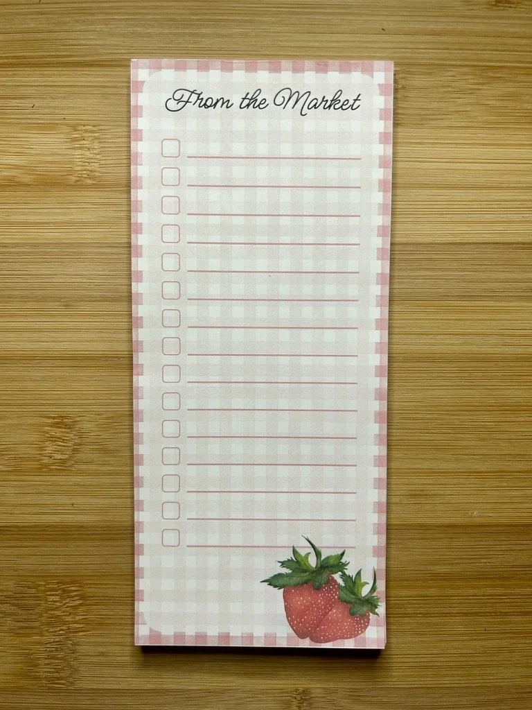 Handmade strawberry magnetic grocery list pad with pink gingham pattern, checkboxes, writing lines and hand-illustrated strawberries.