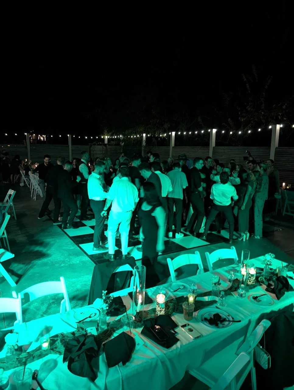 DJ booth setup and uplighting for a wedding reception at a Missouri outdoor reception.