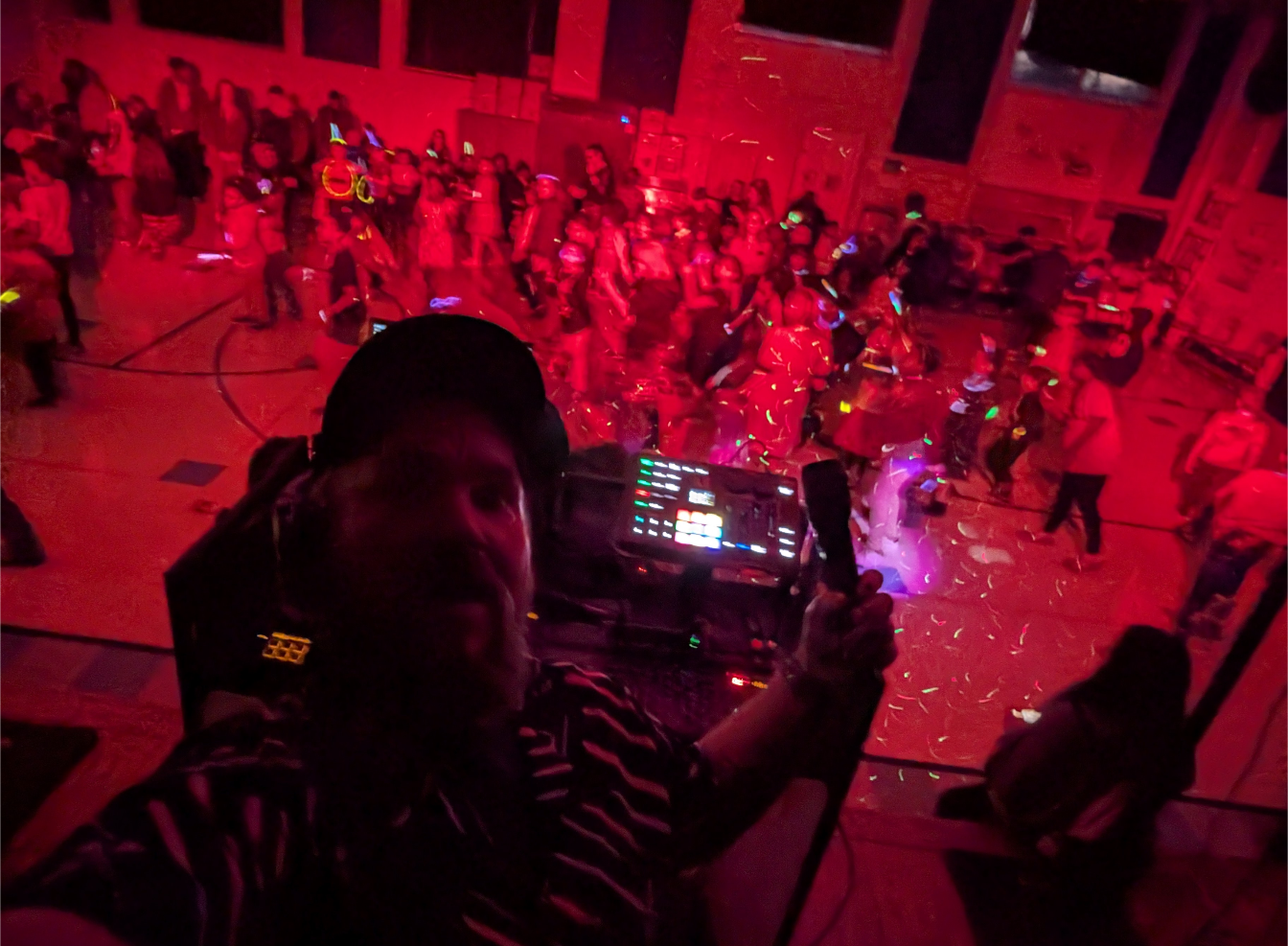 Packed school dance floor with DJ lighting