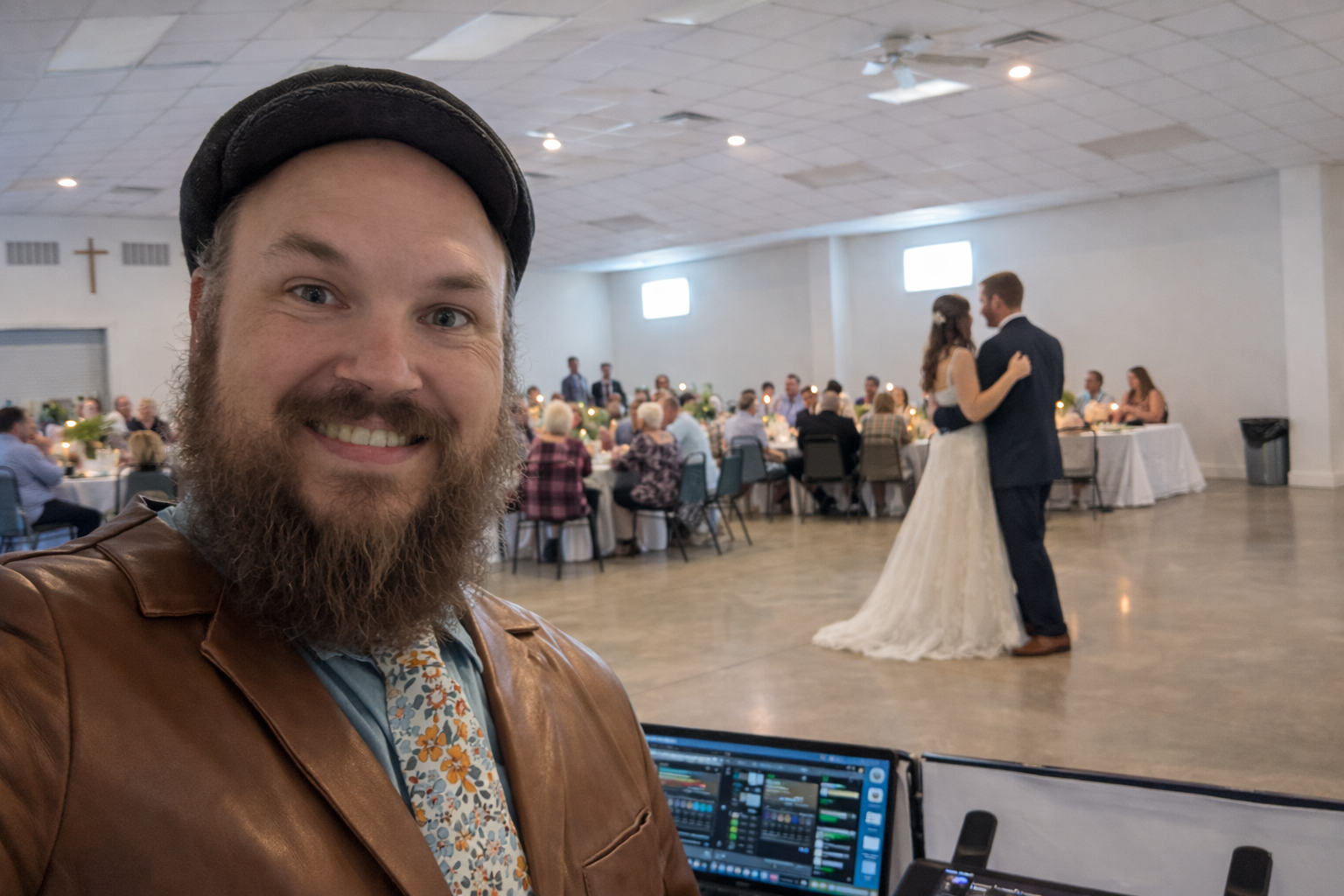 DJ Jazzy Josh at a Columbia, MO wedding reception, mixing music for a full dance floor.
