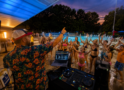 Students dancing at a school event with DJ lighting