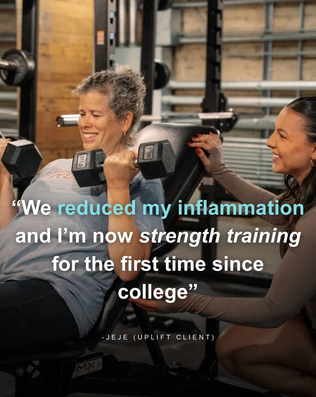 An elderly woman lifting dumbbells during strength training with a trainer helping her in a gym.