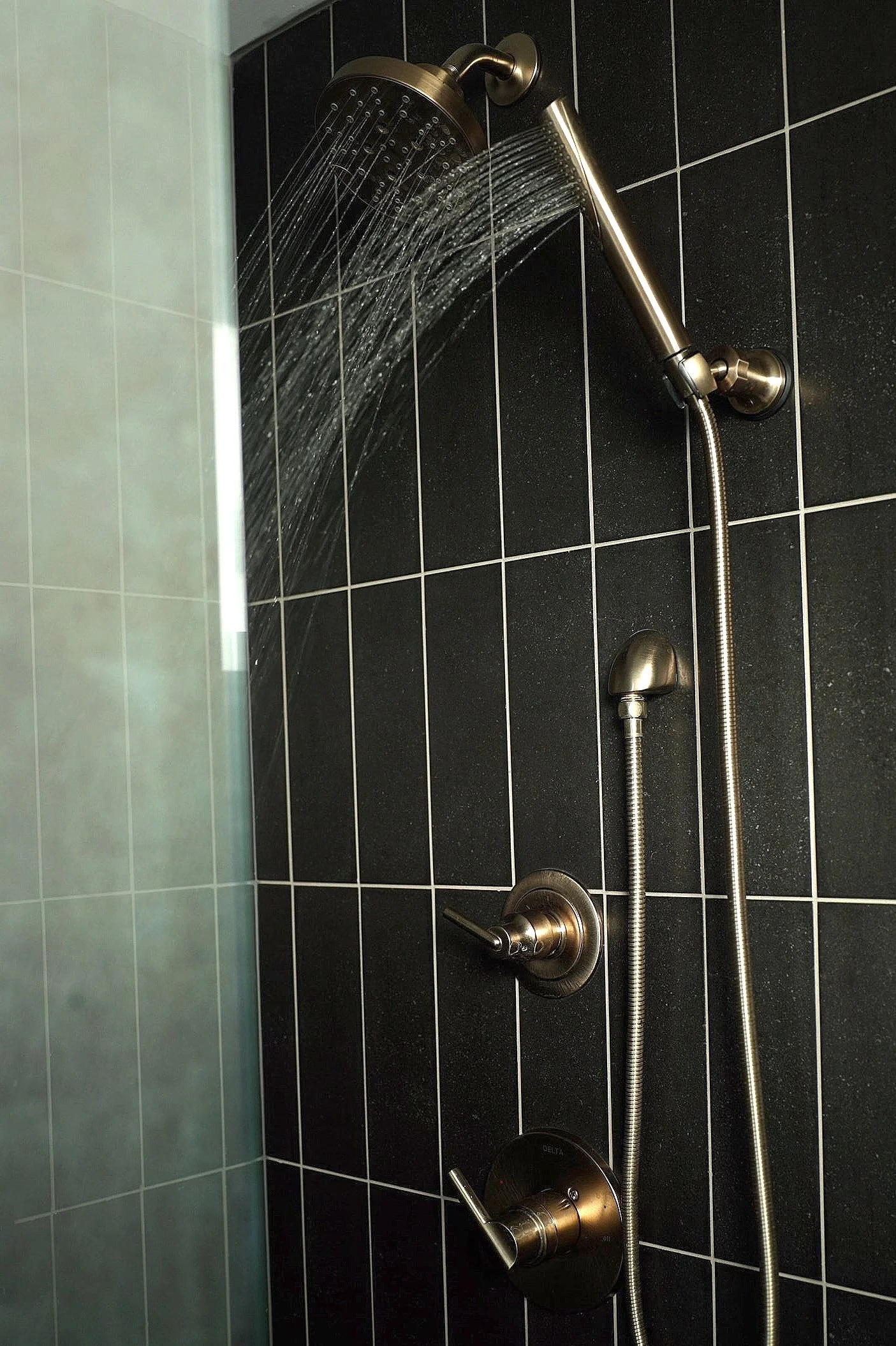 beautiful custom tile shower in custom bathroom with dual head, handheld wand