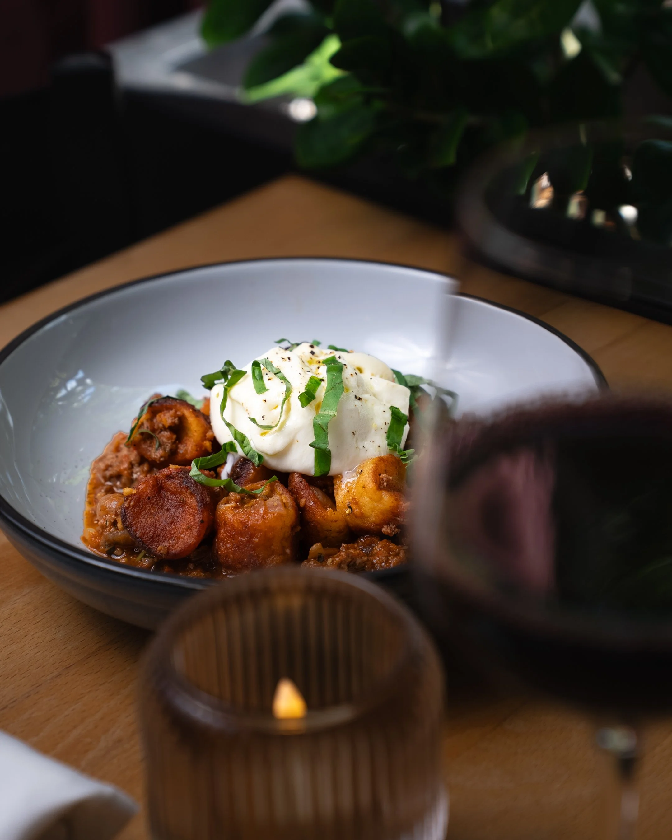 Image of Ricotta Gnudi & red wine on table