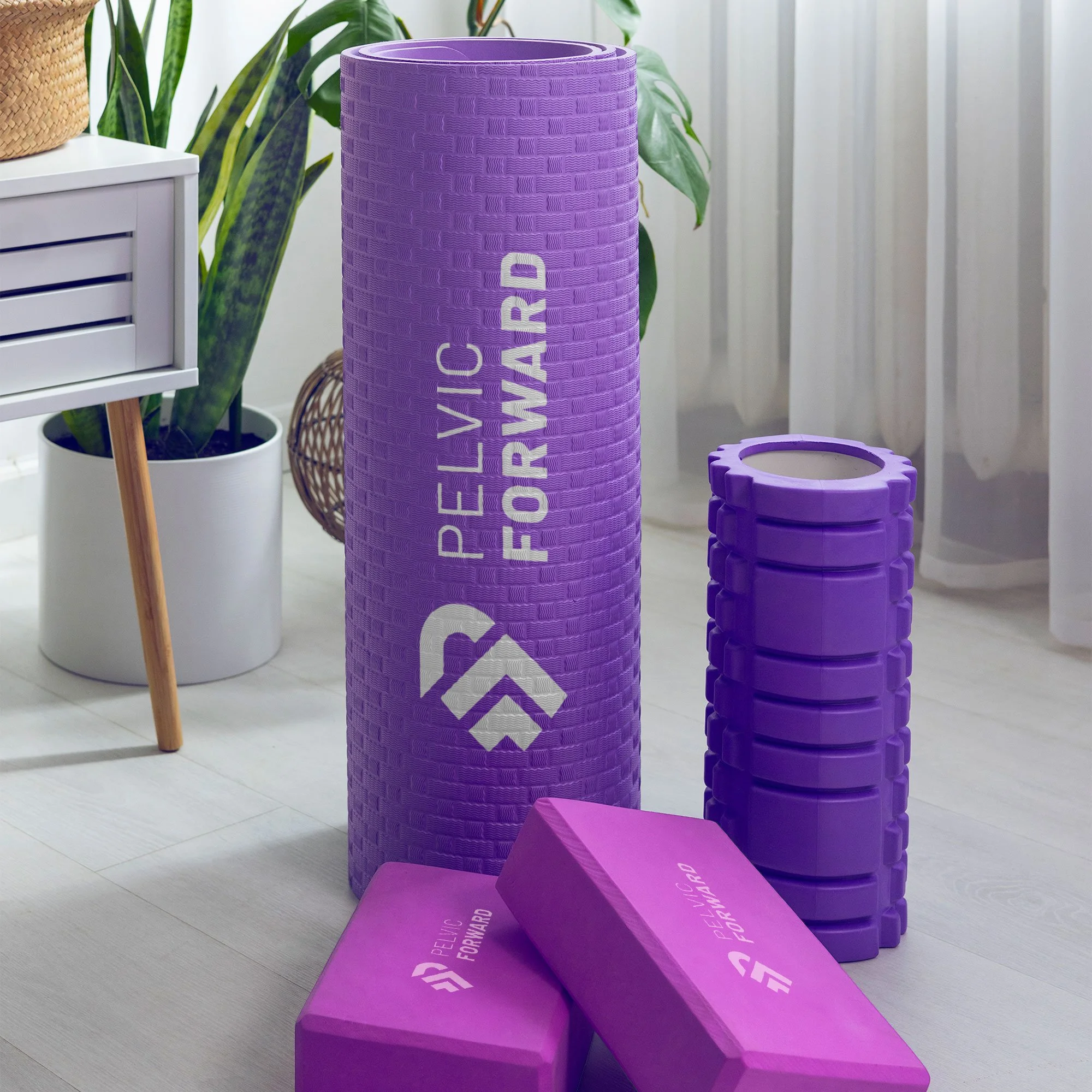 Pelvic Forward logo on physical therapy foam roller and exercise blocks