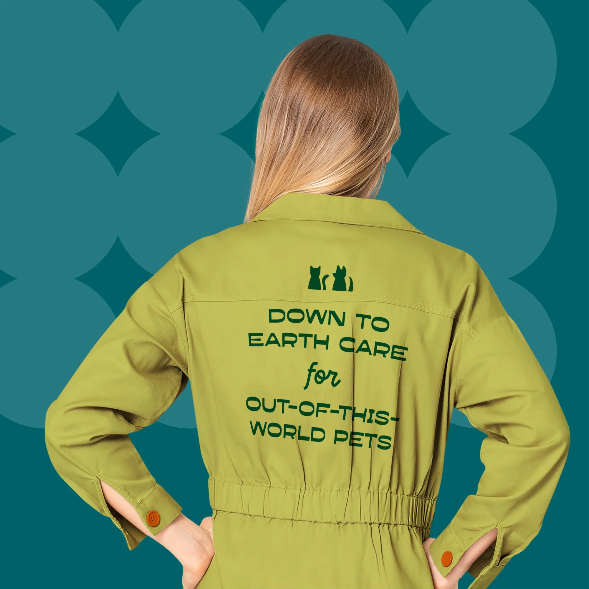 Back of a woman wearing a chartreuse work suit that says "down to earth care for out-of-this-world pets" in navy futuristic text with a dog and cat icon above it