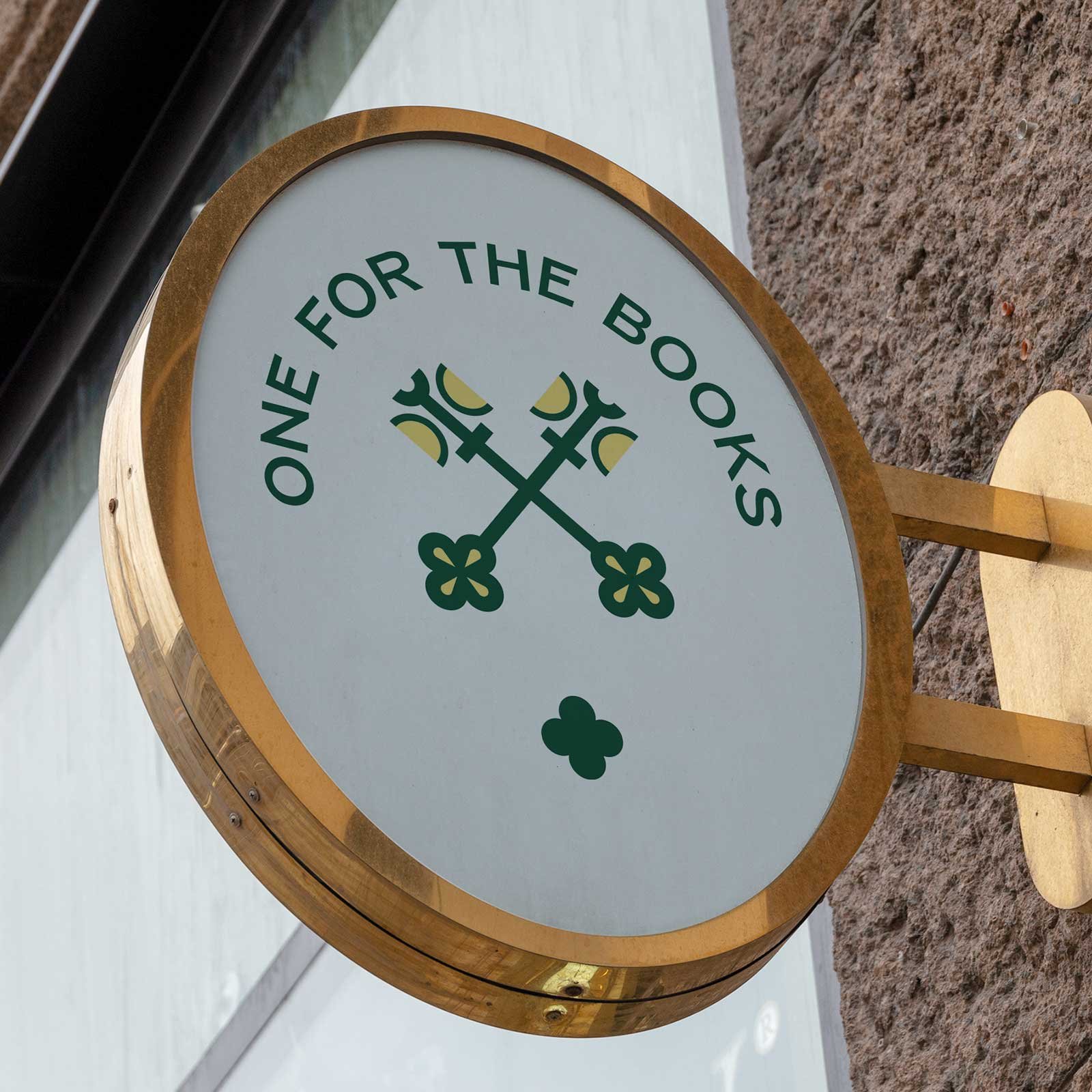 One for the Books Asheville logo on an oval sign on the side of a stone building