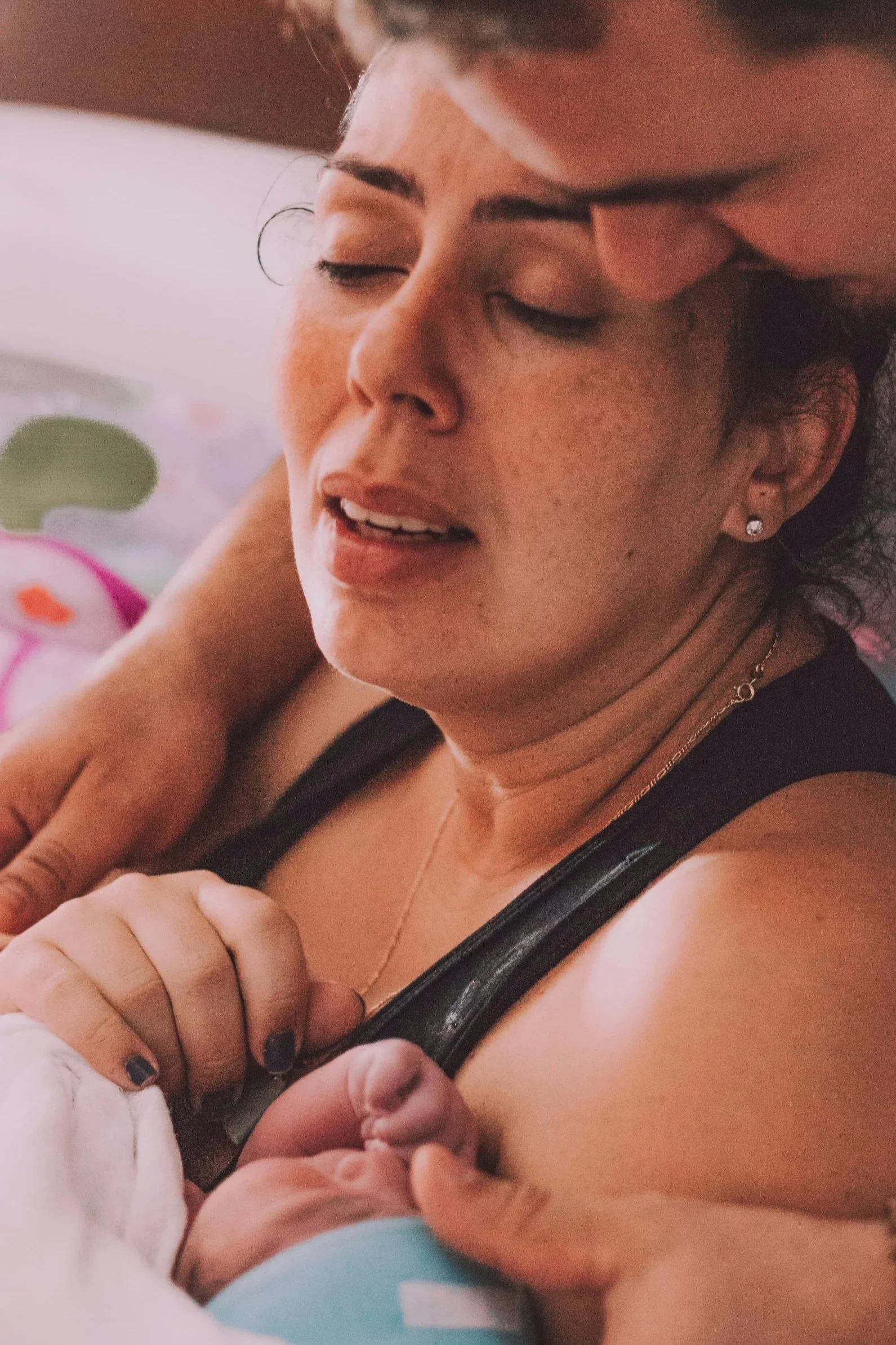 mother with newborn supported by husband