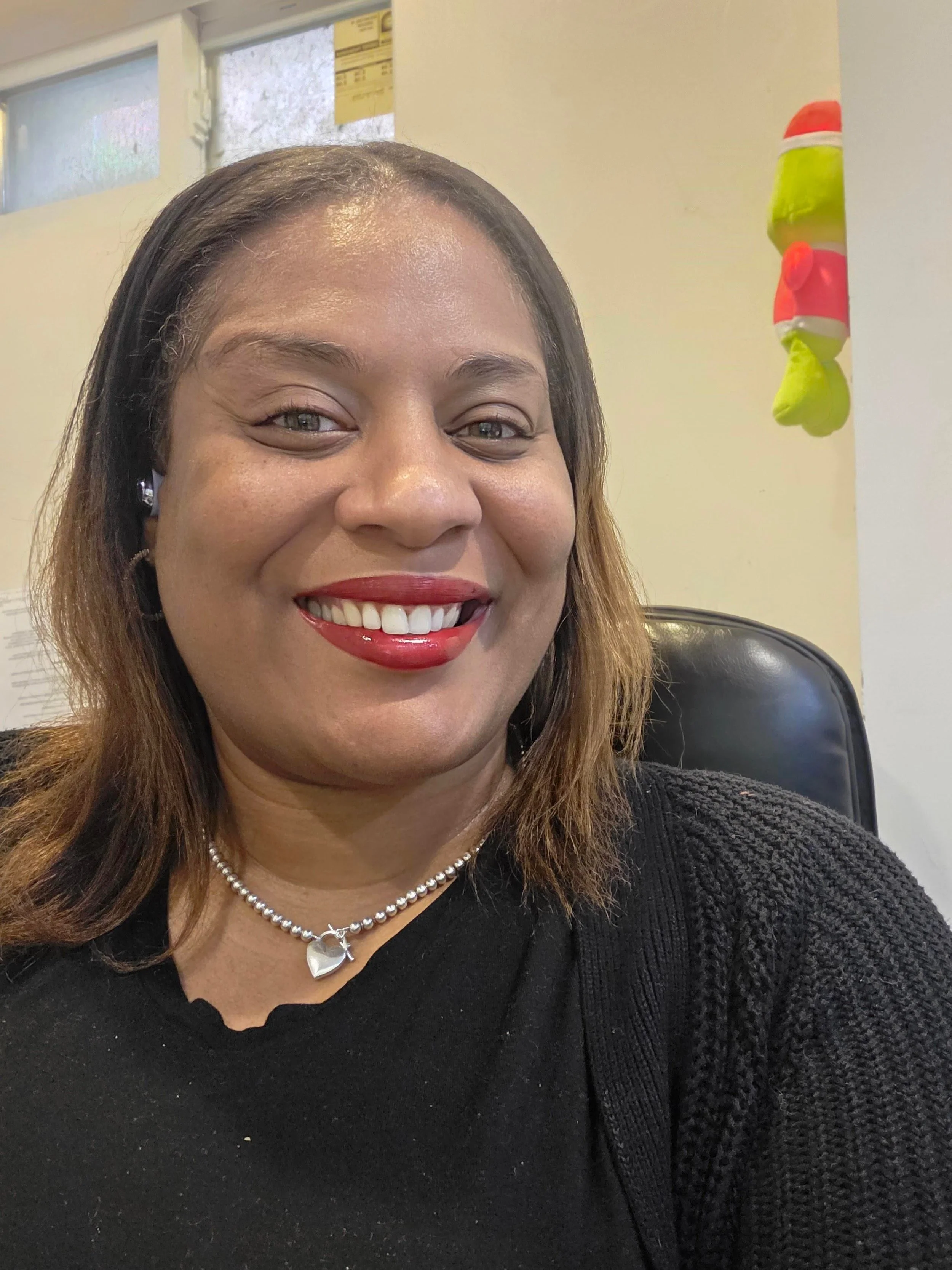 A handwritten sign on white paper with the words "Coming Soon" placed on a light-colored table.