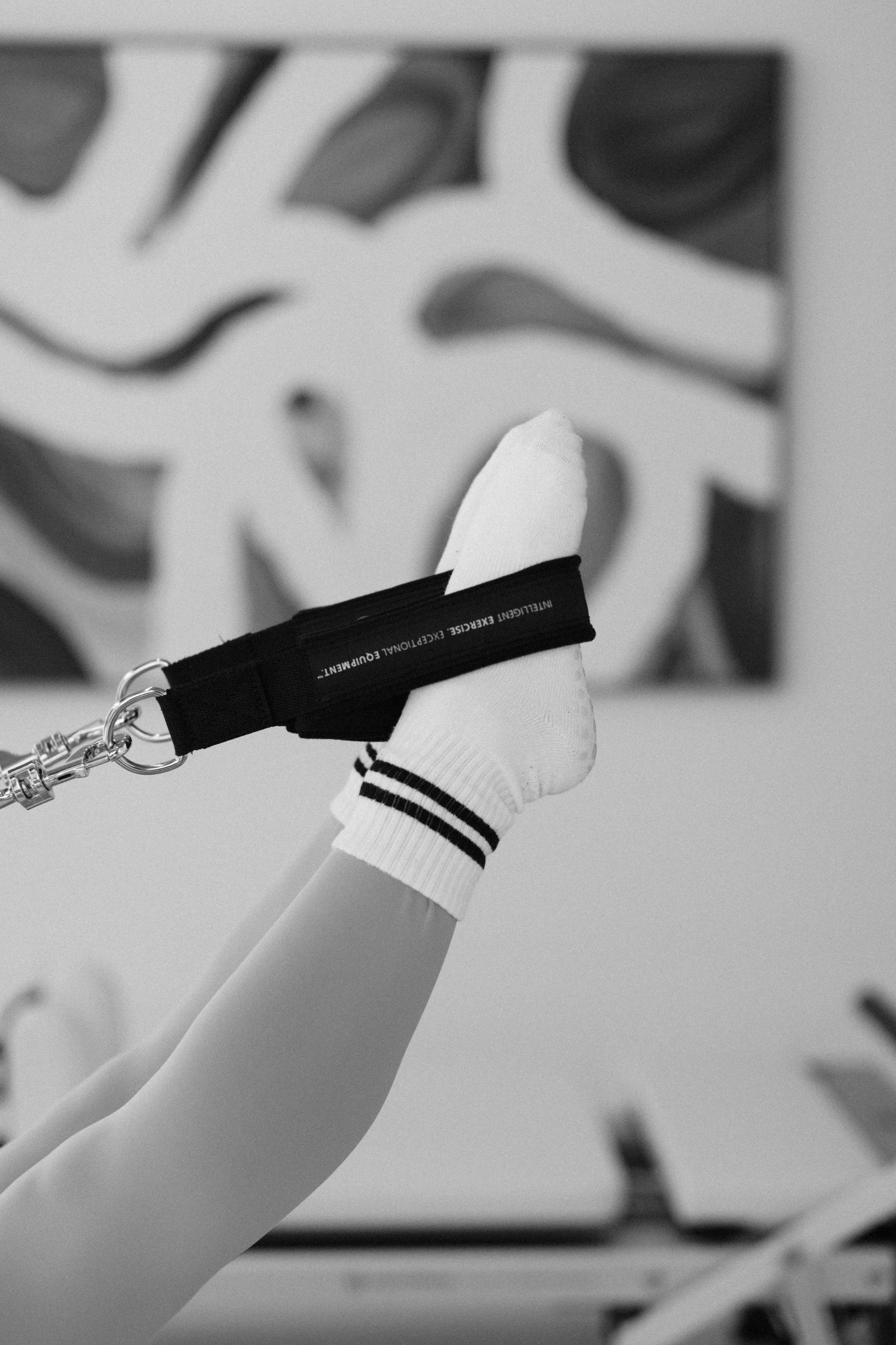 Instructor delivering individualized guidance and cueing during a semi-private reformer session