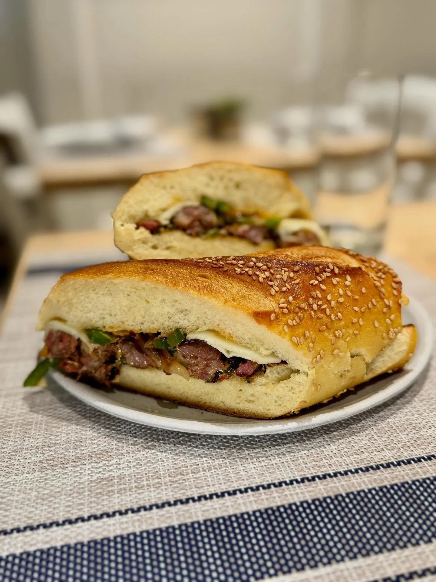 The in development (🤫) Greek-style Sausage and Pepper hero! Grilled loukaniko, melted kefalograviera, truffle mayo, saut&eacute;ed onions and peppers in fresh semolina bread. We are still tweaking it, but check in from time to time. It all depends o