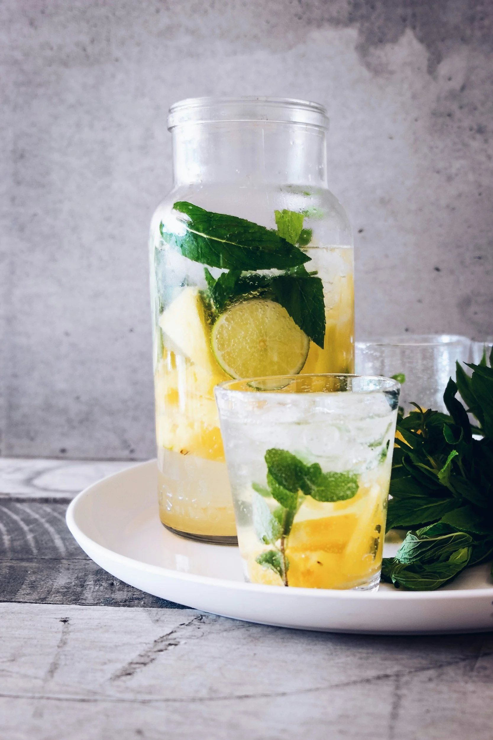 The Mark of Massage Blog | What Happens to Your Body After a Deep Tissue Massage? | a glass and picture of infused ice water with lemon and ment