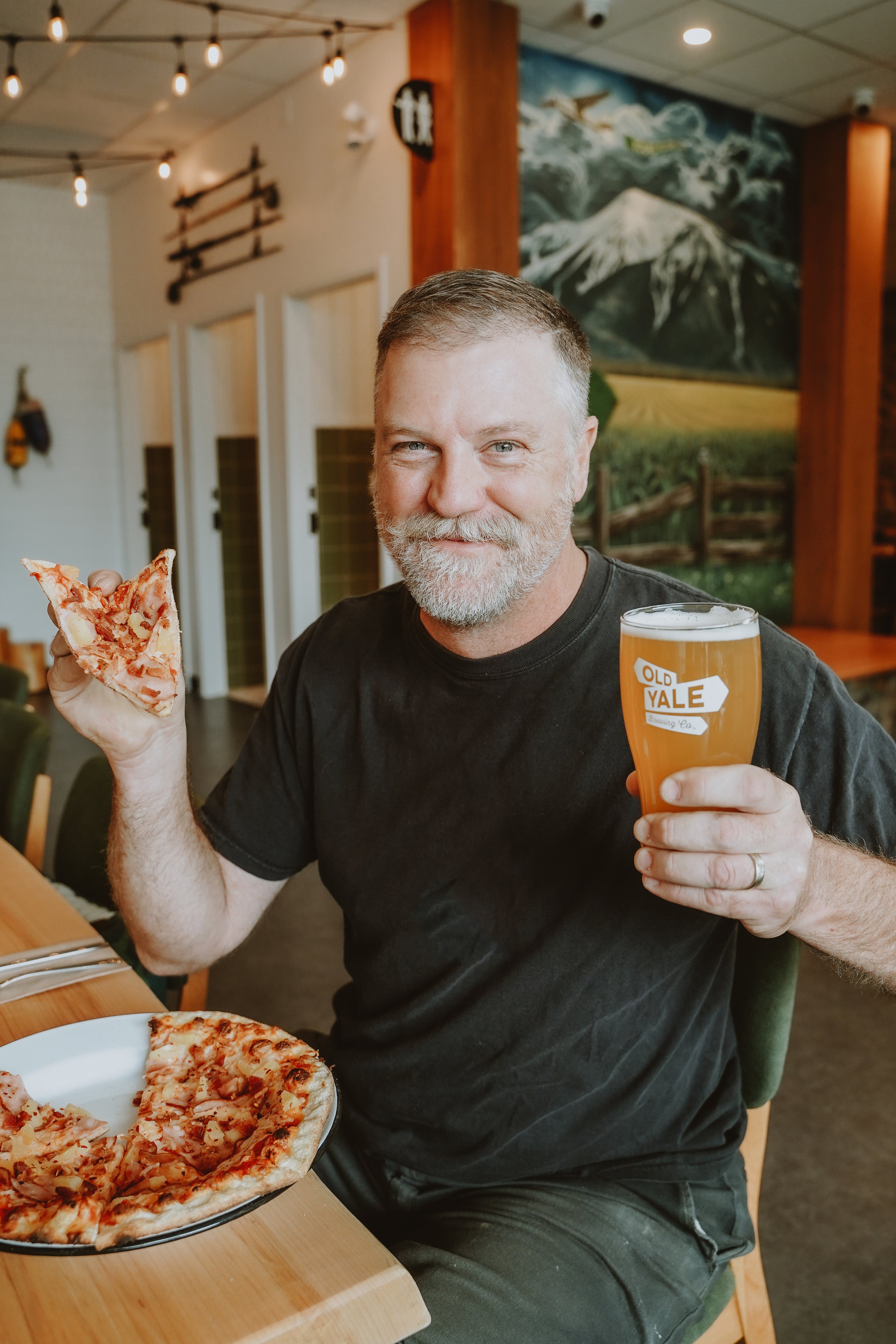 Two guests enjoying craft beer and food at Old Yale Brewing Chilliwack