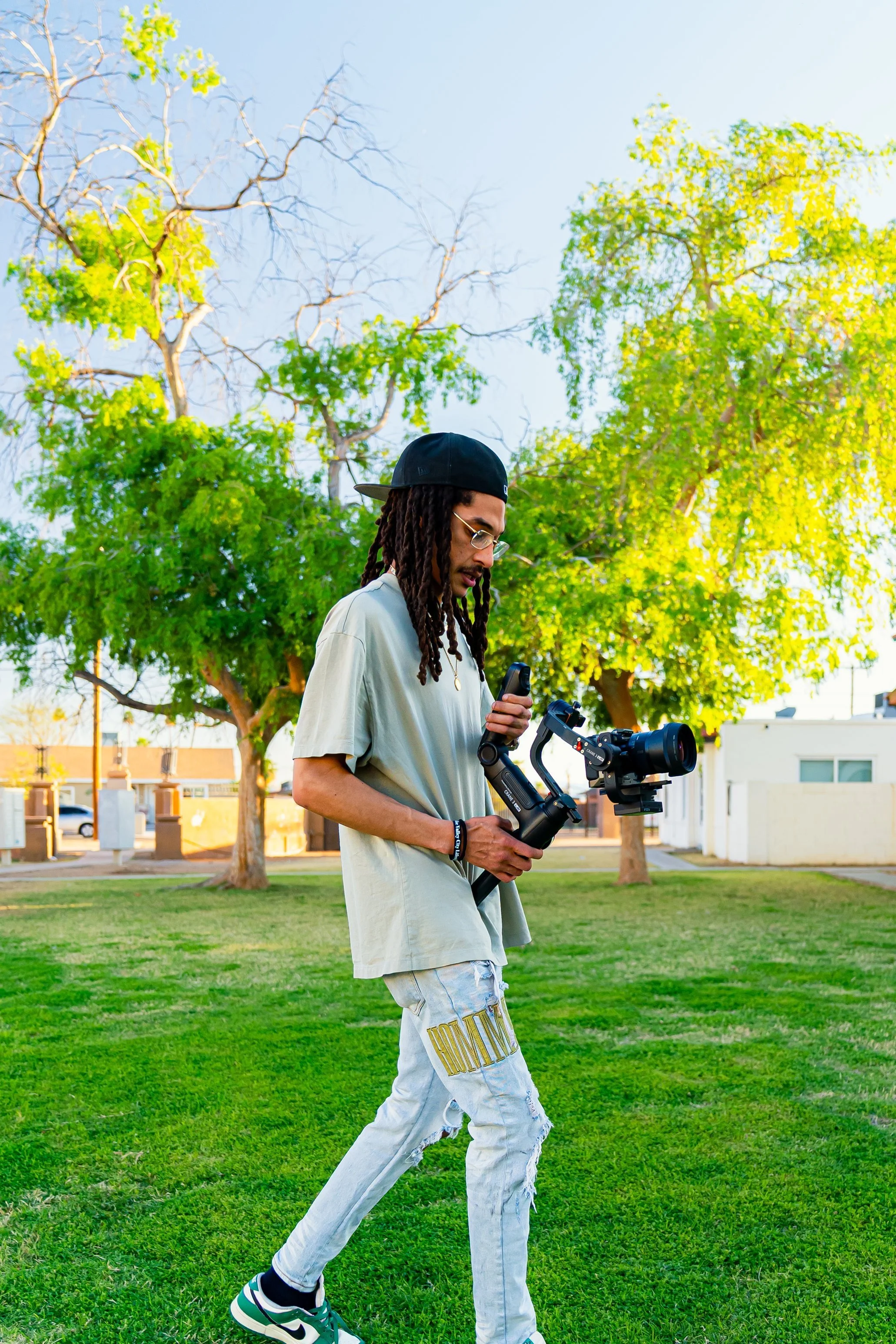 Nappy Behind The Scenes Shooting KT Intellect's "Avenue" Music Video. Featuring Dela Preme and Emmitt Dupree. Bight Sunny Day, Green Grass, Essentials Light Green Tee Shirt