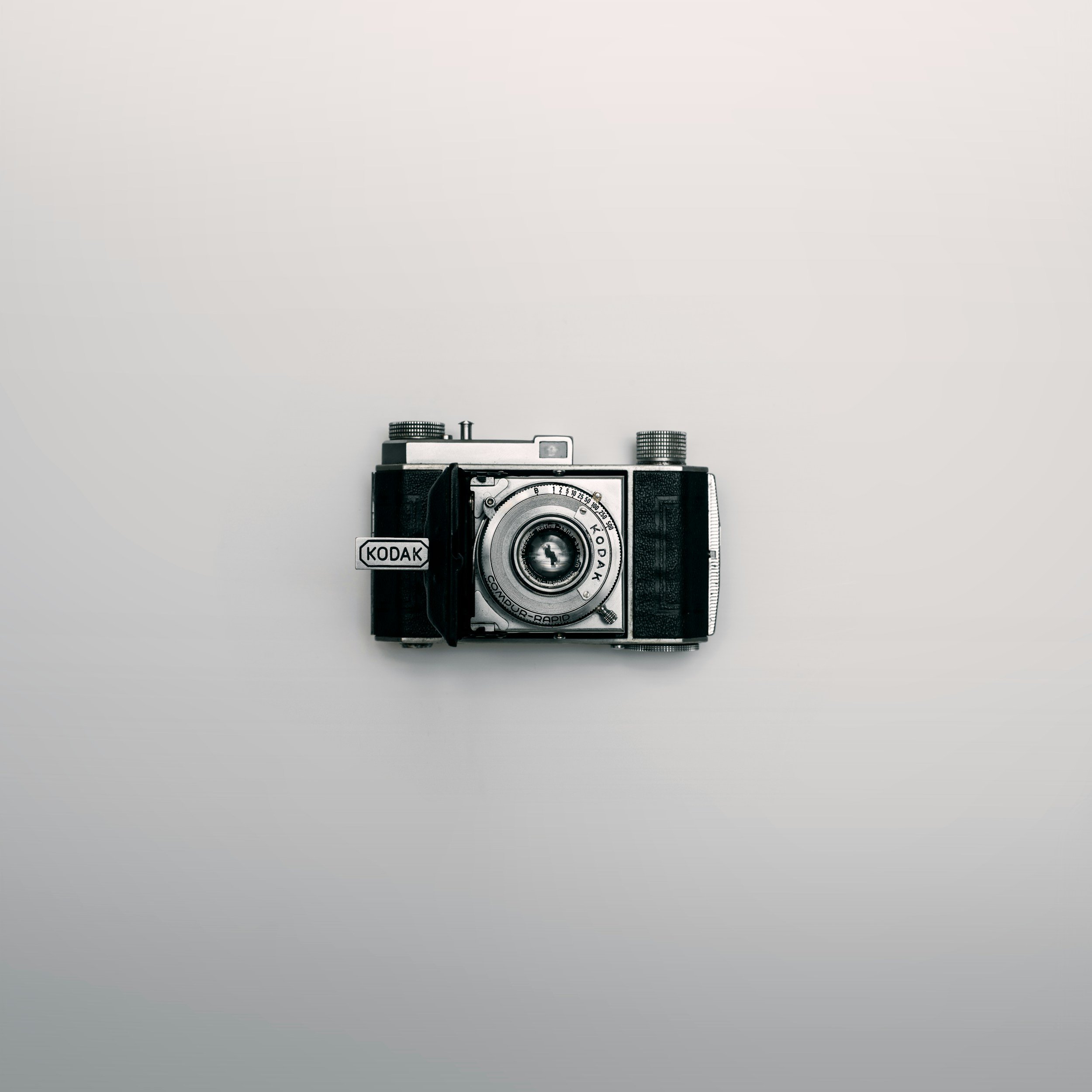 A vintage Kodak film camera placed on a plain white background.