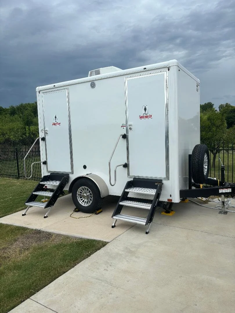 DFW King Service 2-station restroom trailer parked on a driveway