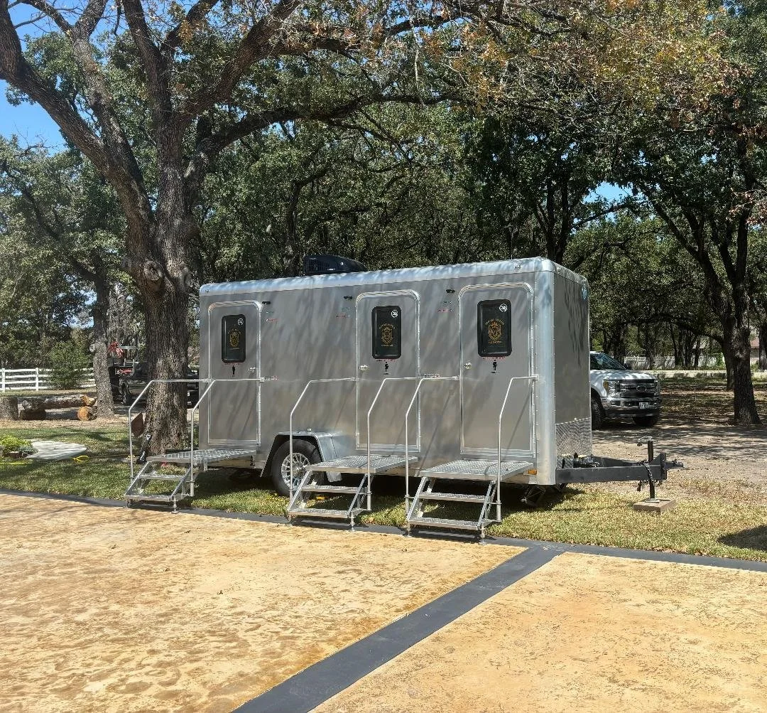 DFW King Service 3-station restroom trailer set up outdoors