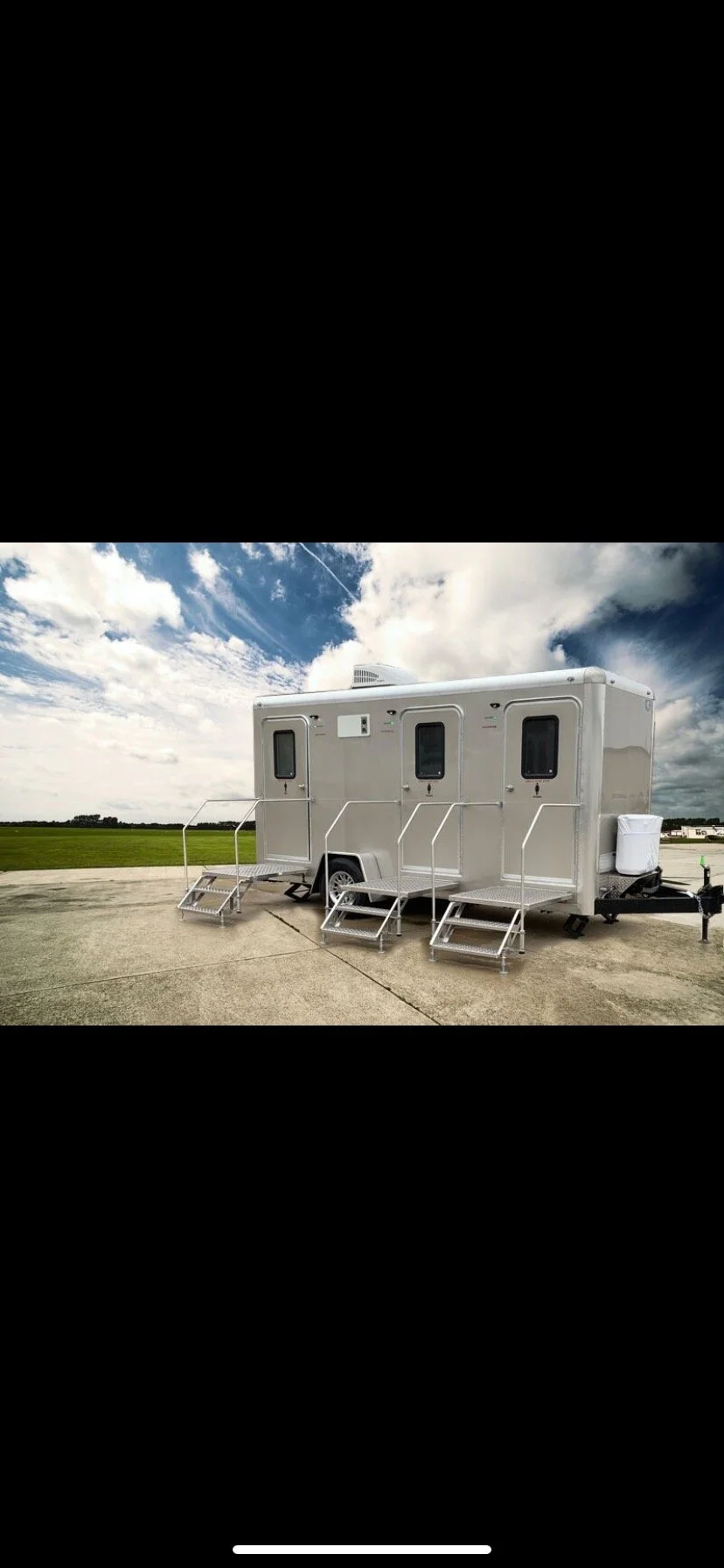 DFW King Service 2-station restroom trailer parked in a grassy field