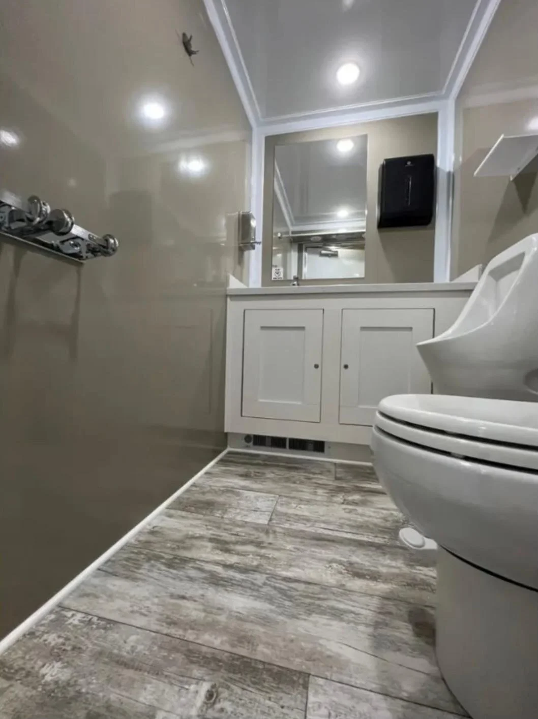 Men's side of a DFW King restroom trailer with sink and lighting
