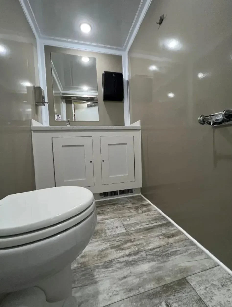 Women's side of a DFW King restroom trailer with vanity and mirror