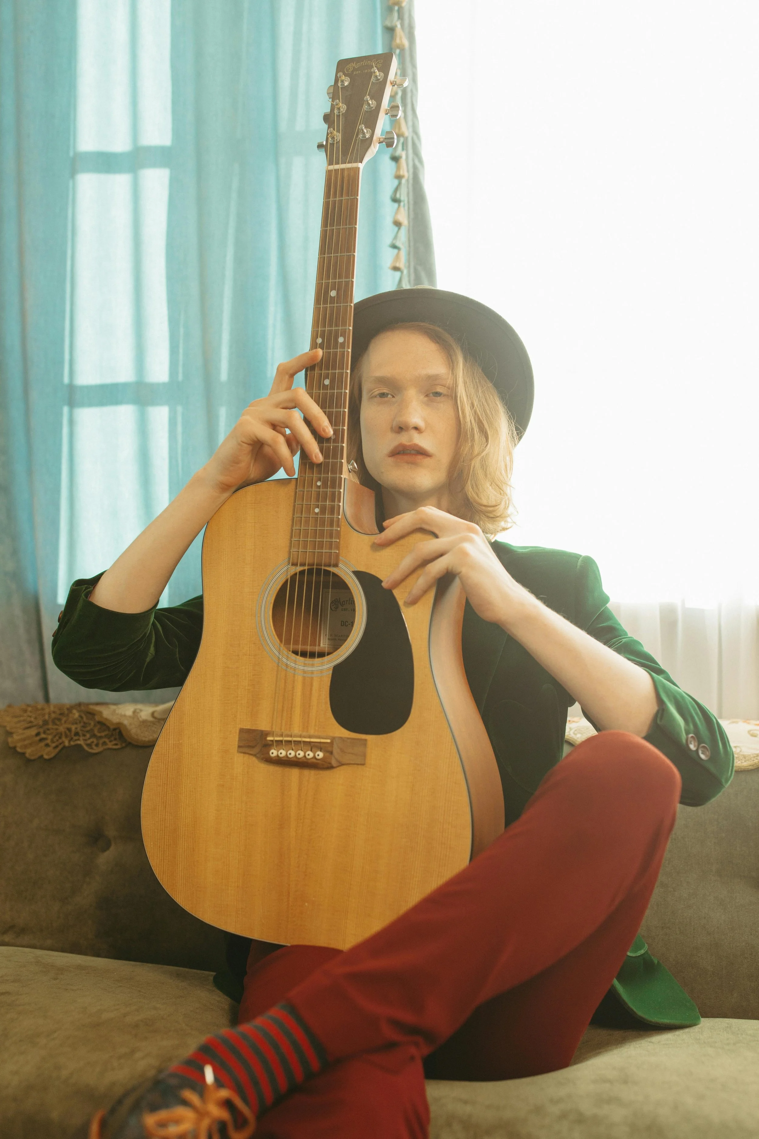 student holding guitar